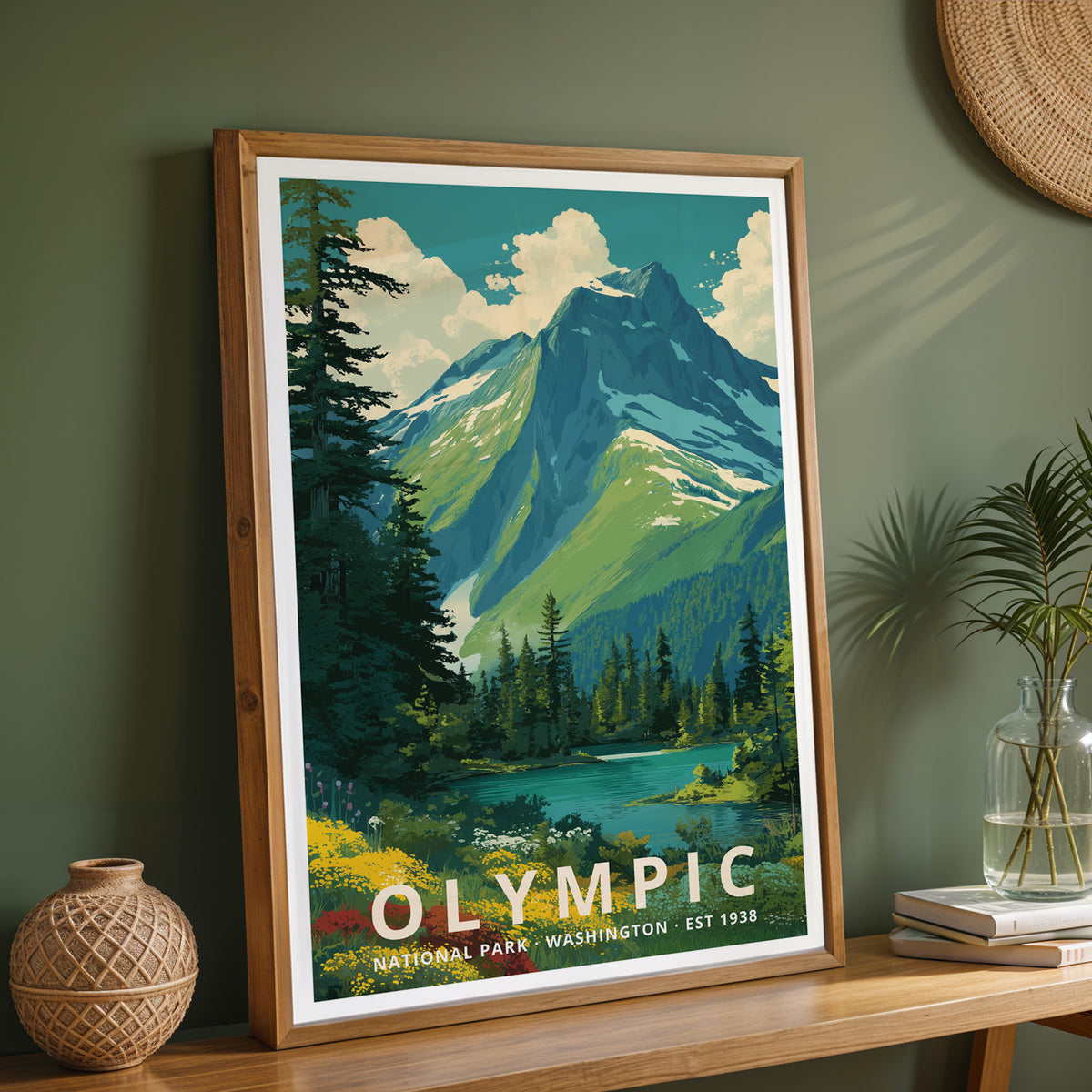 Framed Olympic National Park retro print on a wooden sideboard against a sage green wall with vases and books