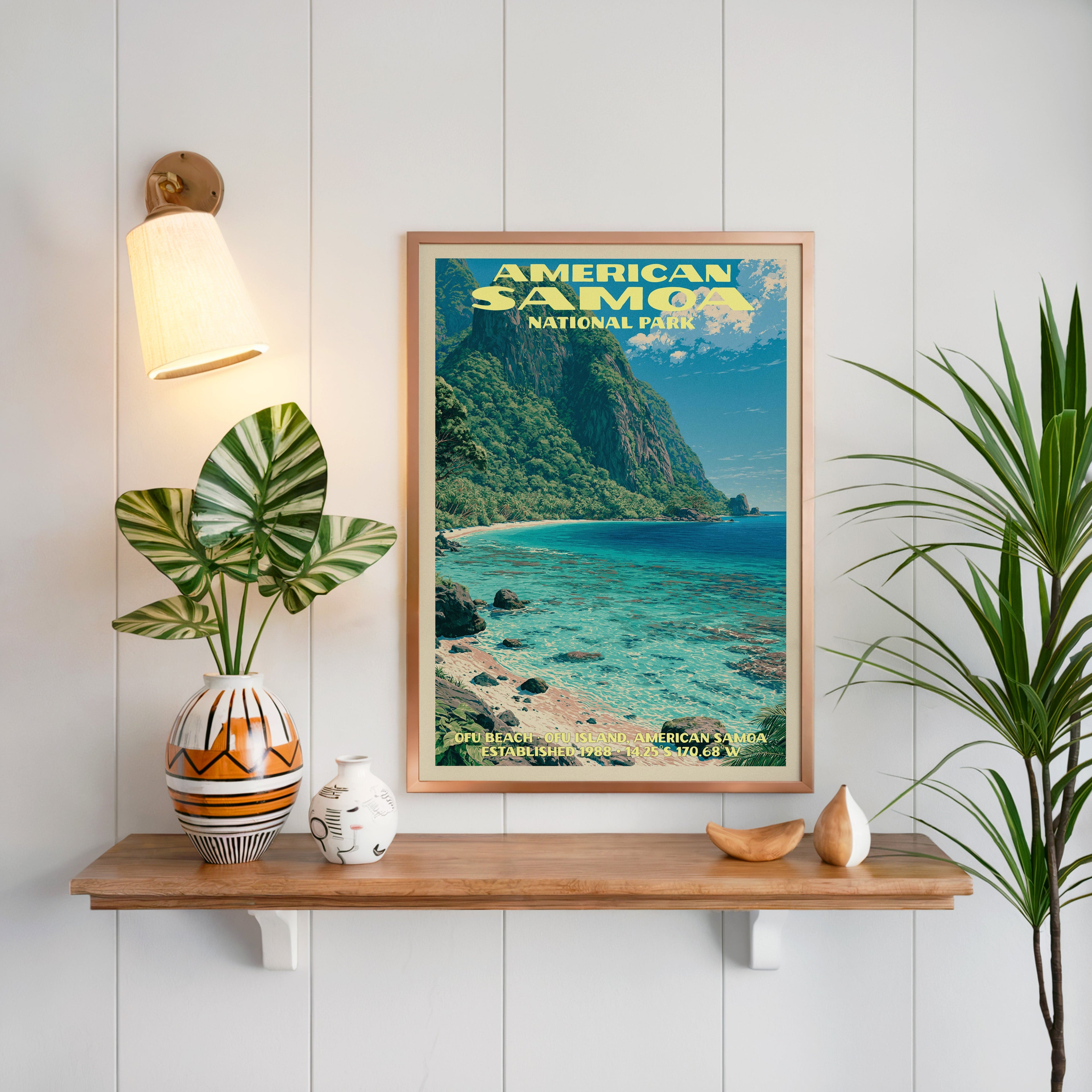 Ofu Beach American Samoa print framed on white panelling above an oak shelf with a patterned vase and sconce