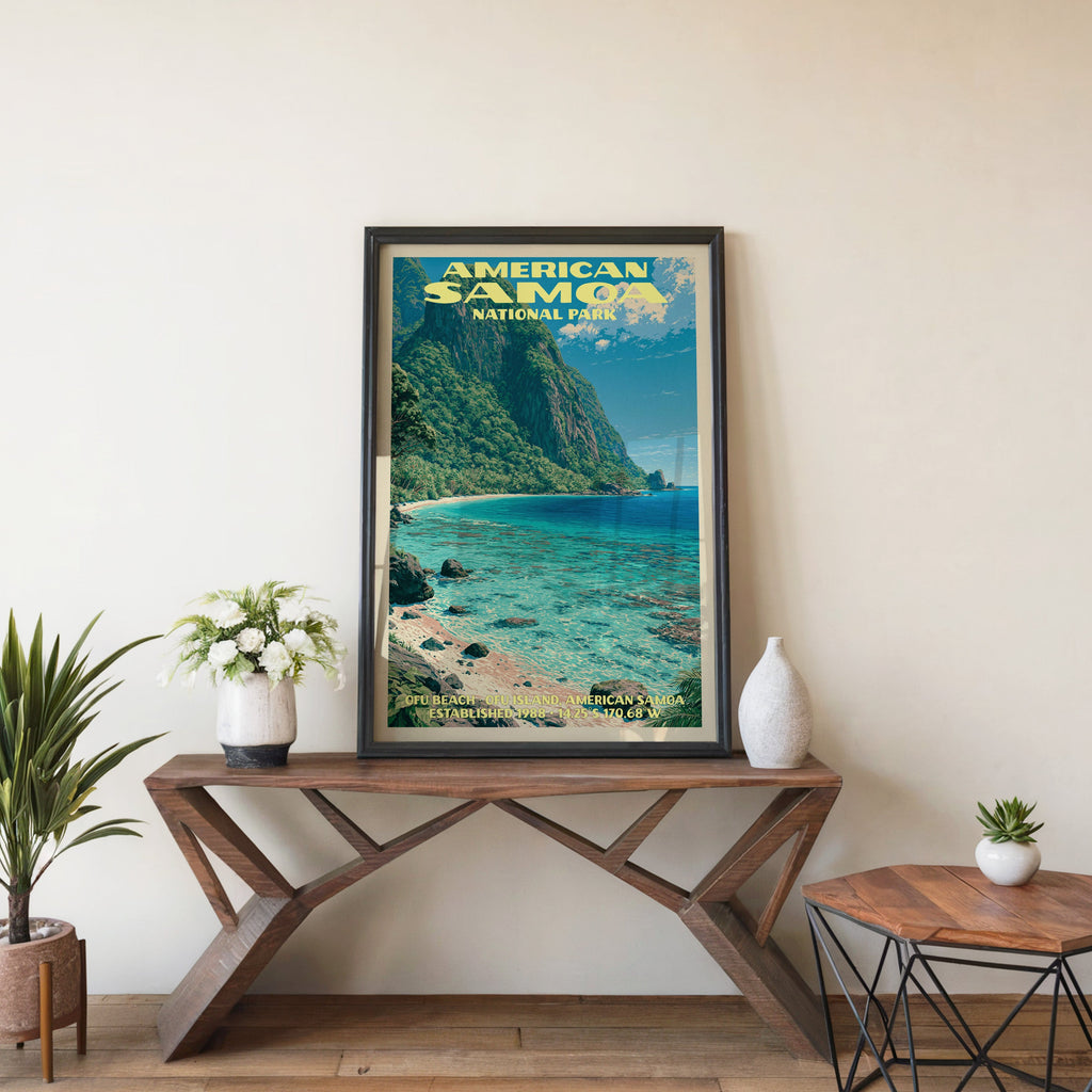 American Samoa Ofu Beach wall art in black, leaning on a walnut console with white anemones and a vase