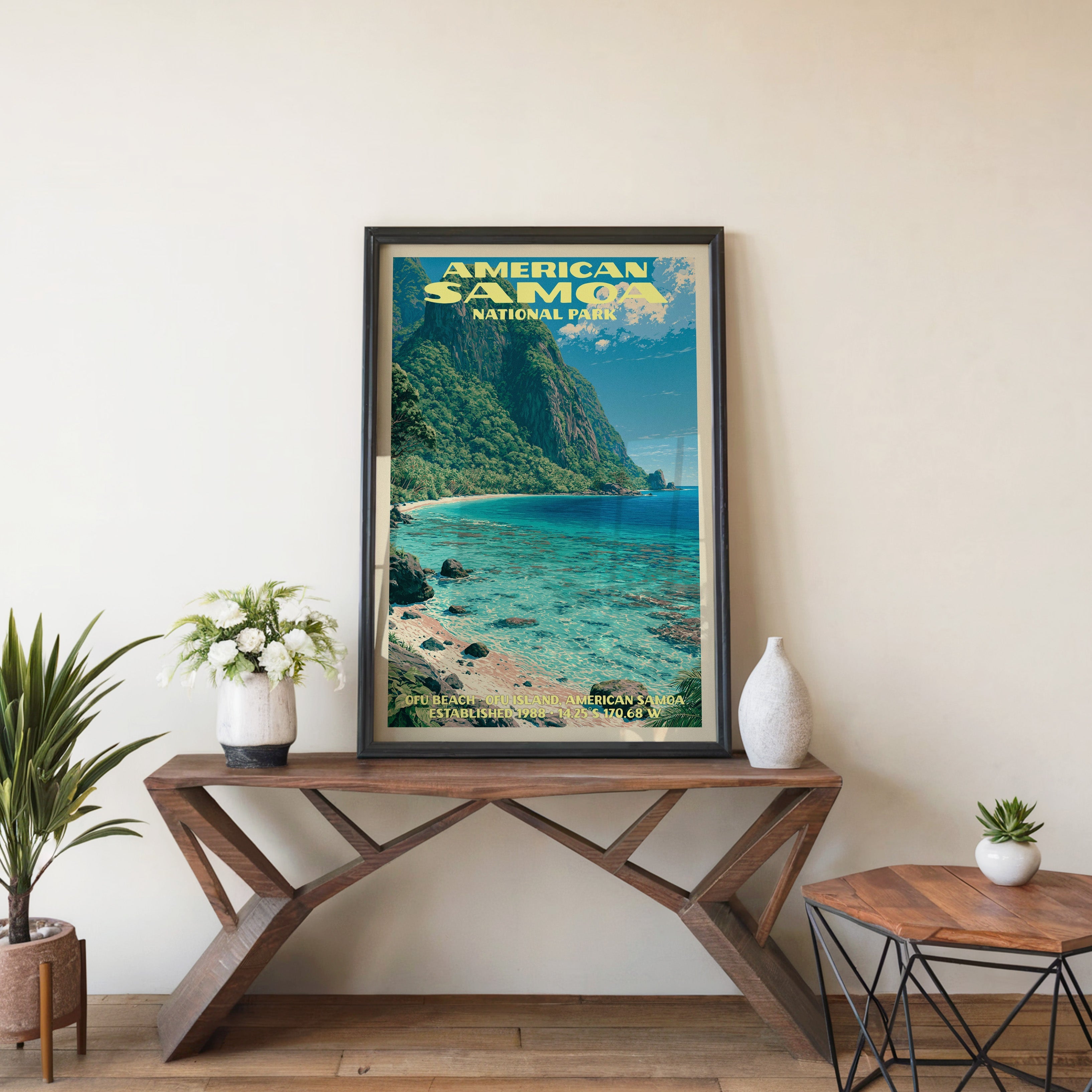 American Samoa Ofu Beach wall art in black, leaning on a walnut console with white anemones and a vase
