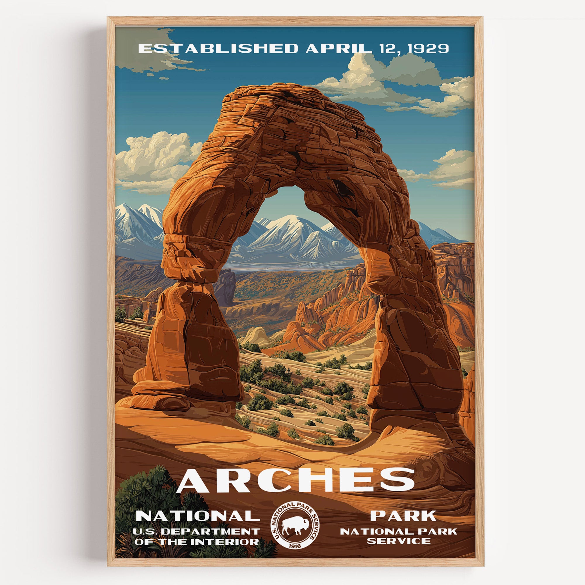 Arches National Park vintage travel poster in a wood frame, Delicate Arch framed against the snow-capped La Sal Mountains
