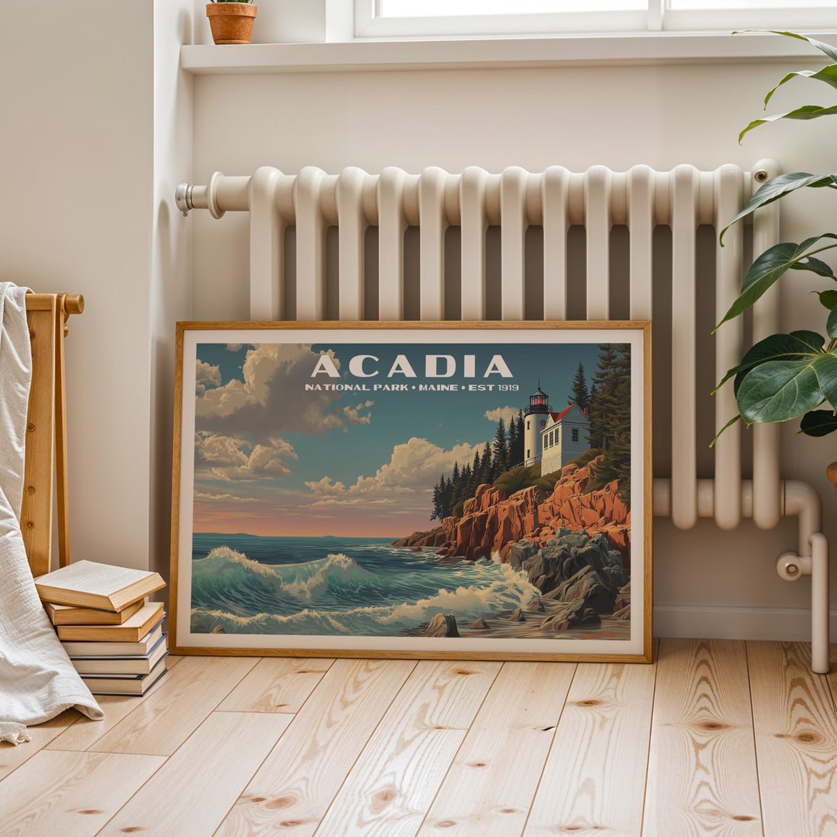 Acadia National Park wall art print in a light oak frame, resting on a pale wood floor against a wall below a column radiator