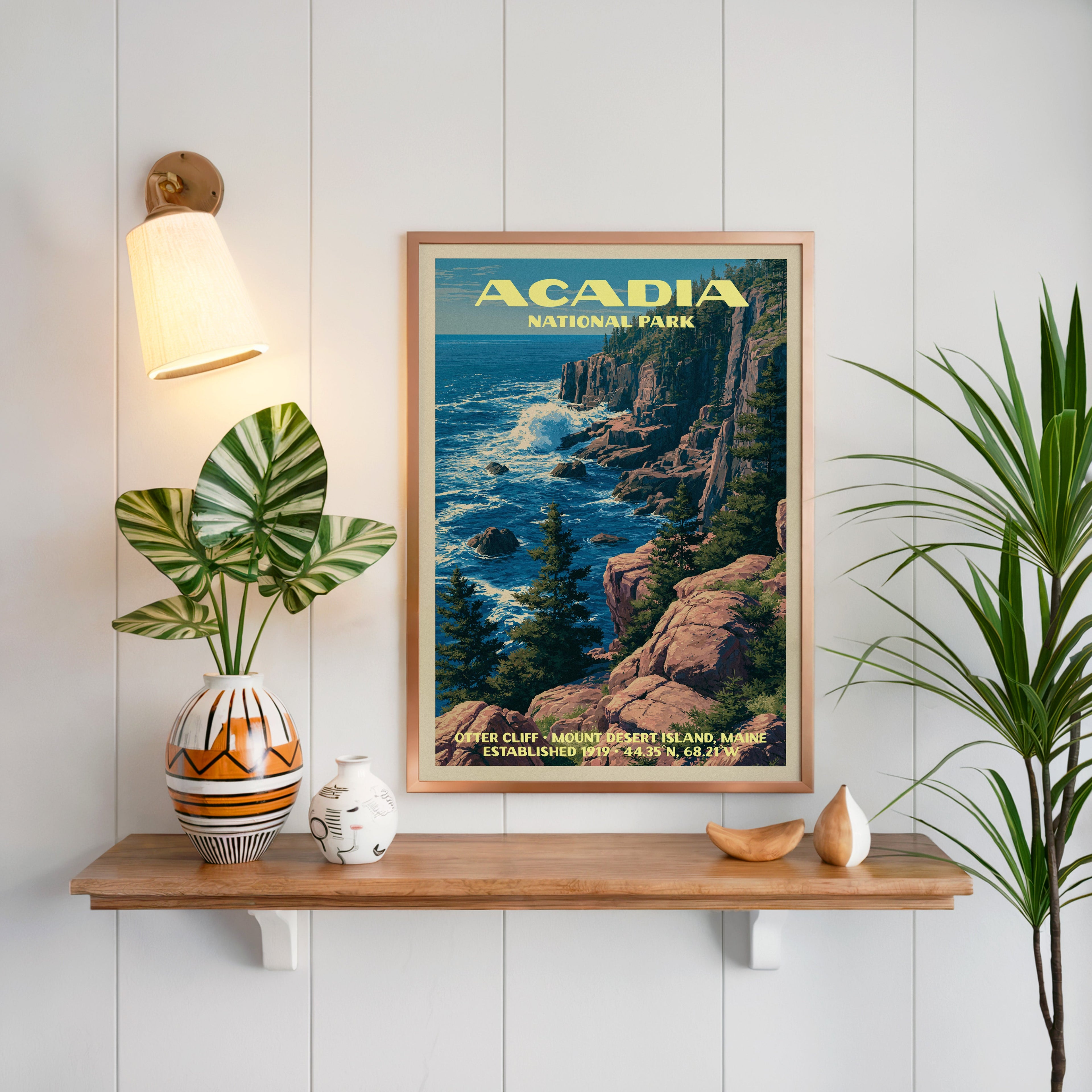 Otter Cliff Acadia print framed on white panelling above an oak shelf with a patterned vase and sconce