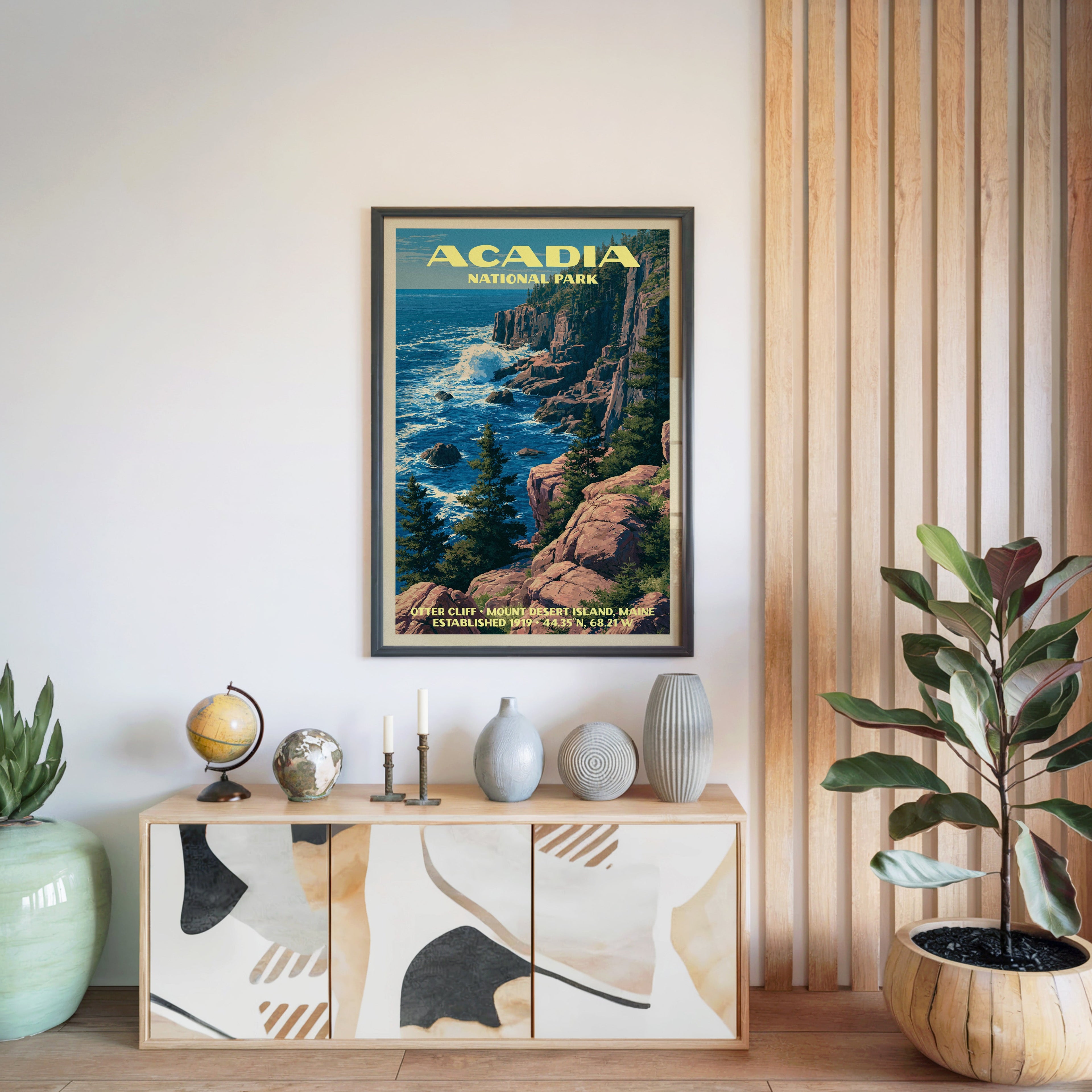 Acadia National Park poster in a black frame above a light wood sideboard by a slatted wall panel