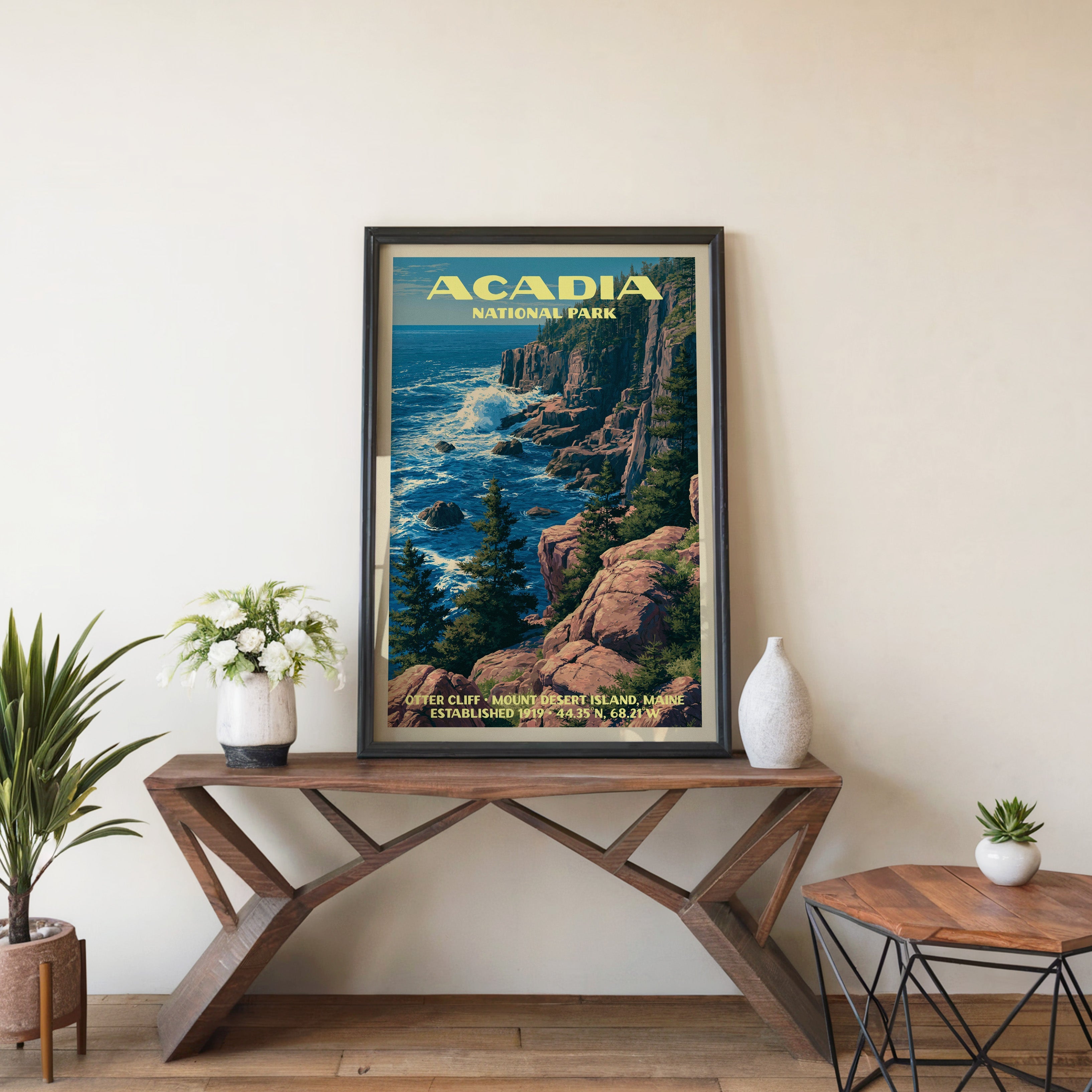 Acadia Otter Cliff wall art in black, leaning on a walnut console with white anemones and a vase