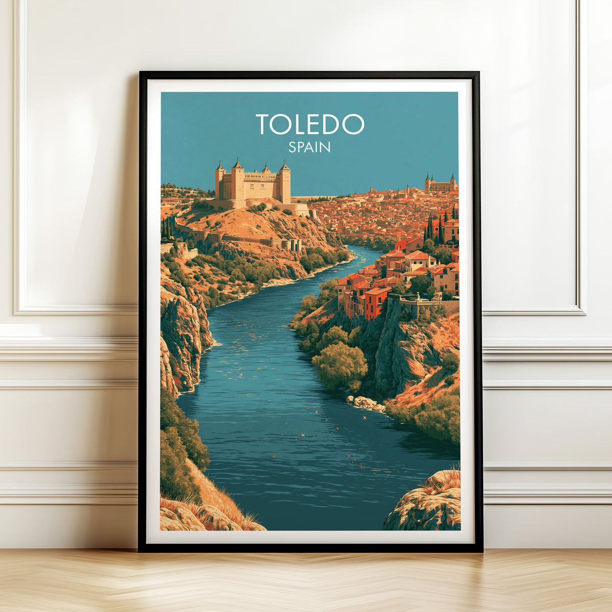 Toledo Tagus gorge print, black frame leaning on a white panelled wall above a herringbone floor