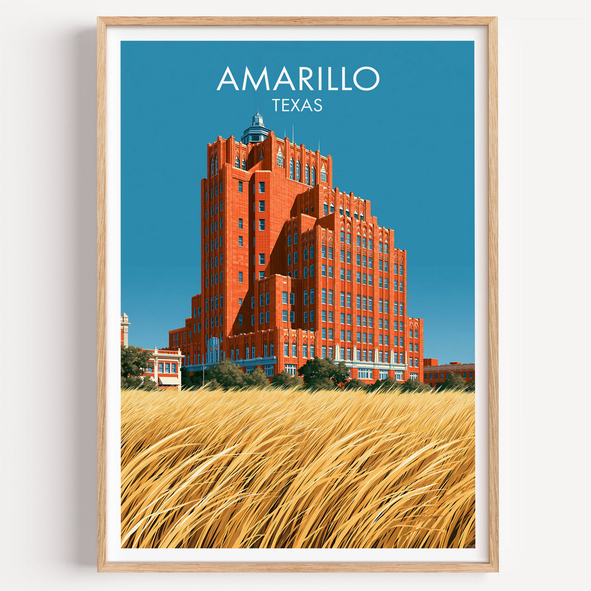 Amarillo brick tower travel poster in a light oak frame on a plain white wall, photographed straight on.