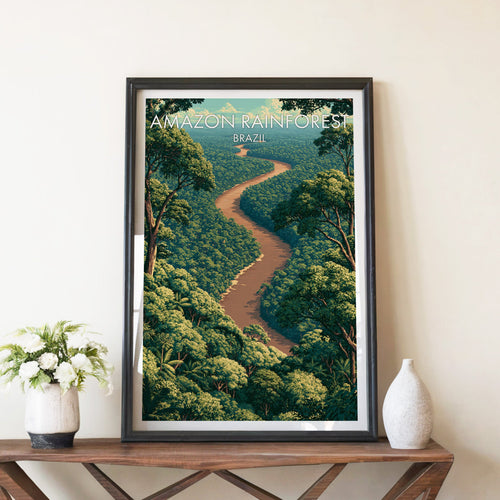 Amazon River print in a black frame on a brown console table with white flowers in a ceramic vase