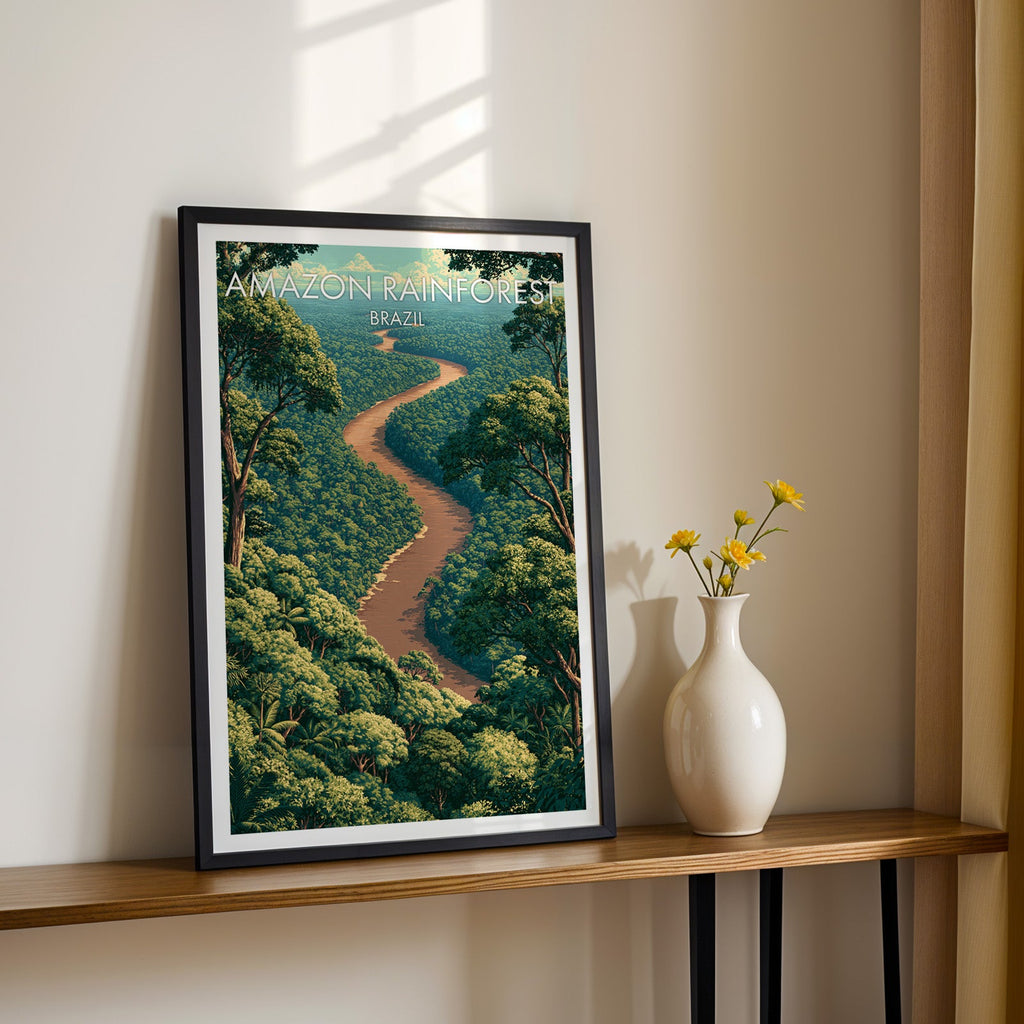 Brazil rainforest wall art in a black frame on a narrow wood shelf with yellow daisies in a white vase