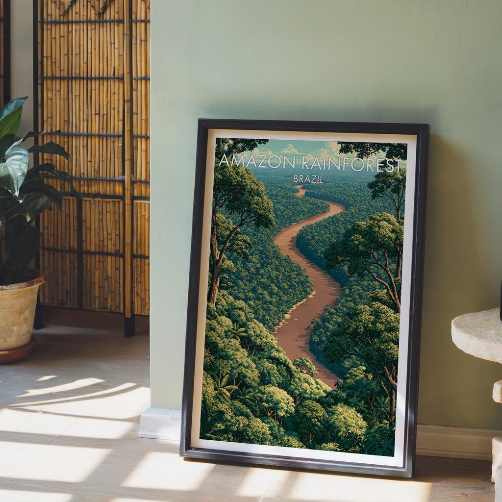 Jungle canopy print in a dark brown frame on light wood floor by a sage green wall and bamboo screen