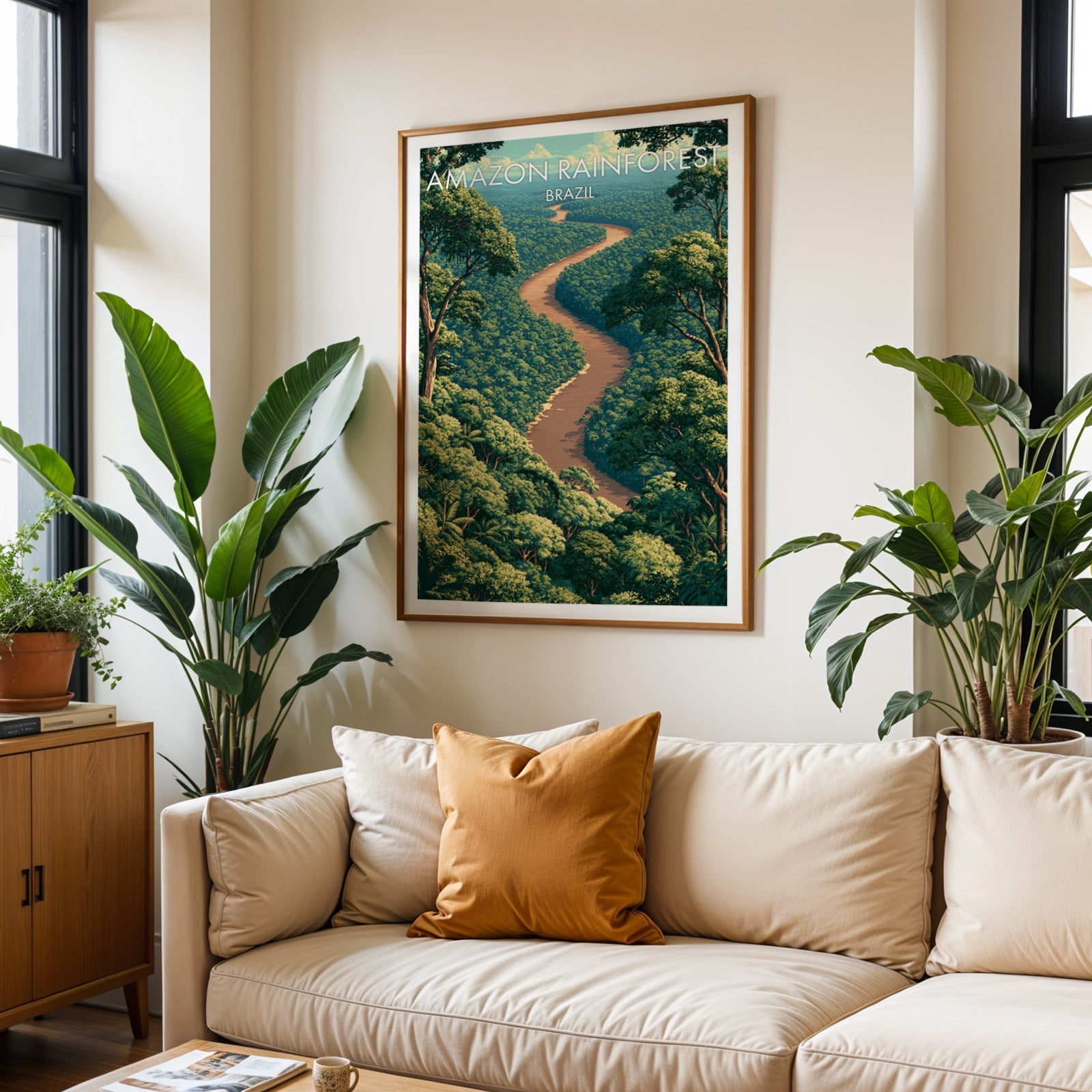 Rainforest river poster in an oak frame above a cream sofa with rust cushions and tropical plants