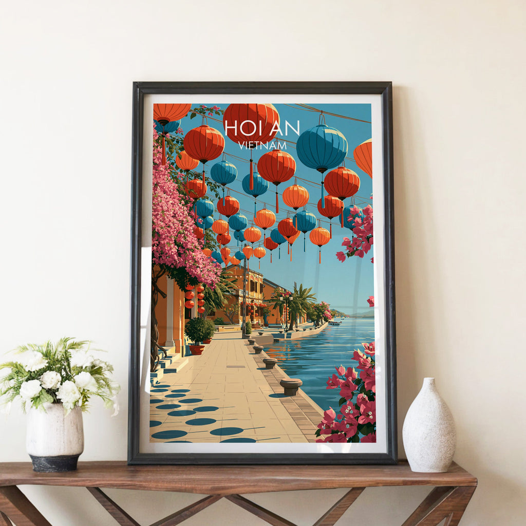 Hoi An Vietnam travel poster in a black frame on a wooden console table with white flowers and vase