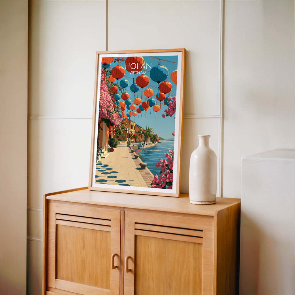 Small Hoi An Vietnam travel poster in an oak frame standing on a mid-century sideboard with a ceramic vase