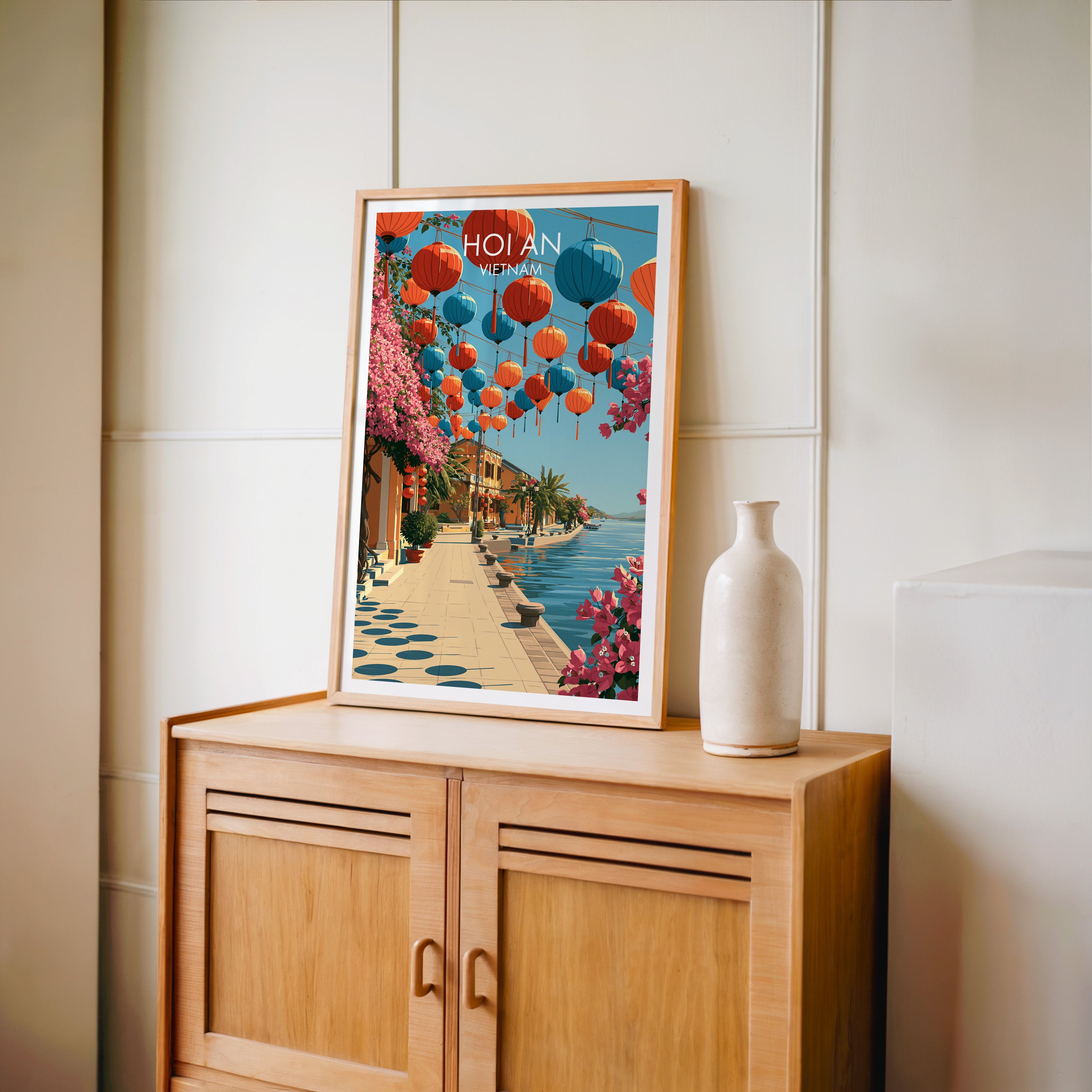 Small Hoi An Vietnam travel poster in an oak frame standing on a mid-century sideboard with a ceramic vase