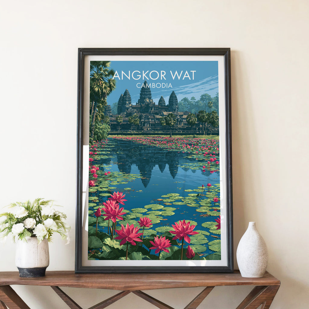 Angkor Wat Cambodia travel poster in a black frame on a wooden console table with white flowers
