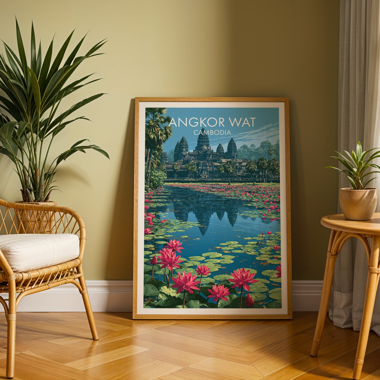 Large Angkor Wat Cambodia travel print in an oak frame leaning on a herringbone floor next to a rattan chair