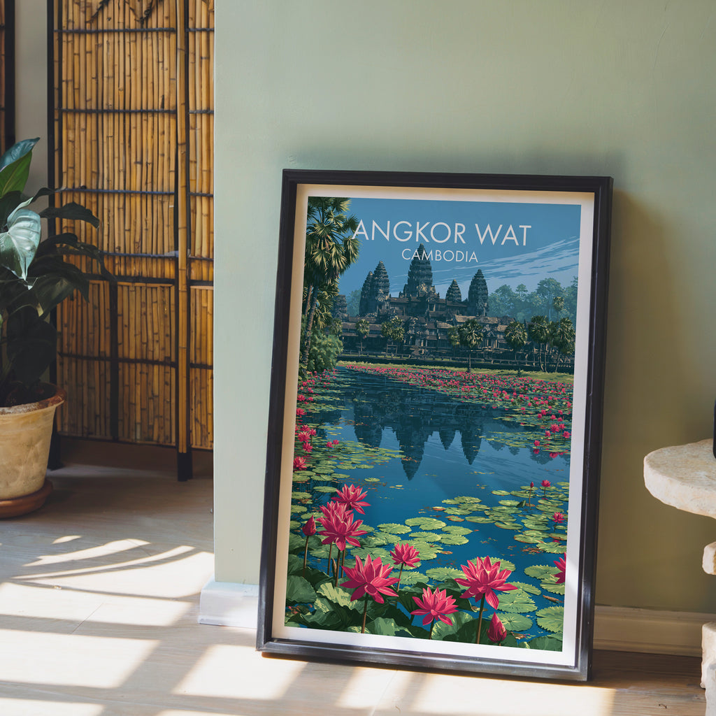 Angkor Wat Cambodia wall art in a black frame leaning against a sage green wall beside a bamboo screen