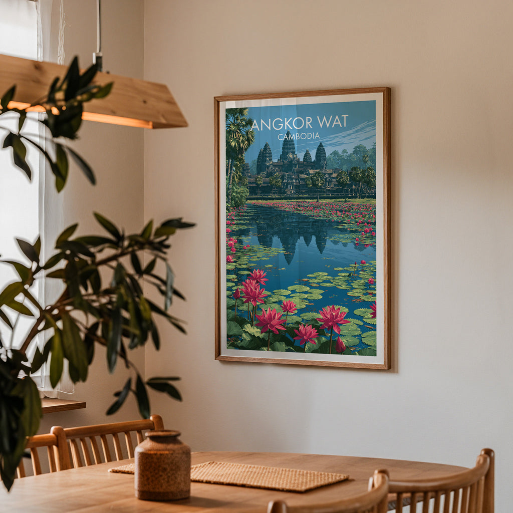 Framed Angkor Wat Cambodia print on a dining room wall above an oak table in warm afternoon light