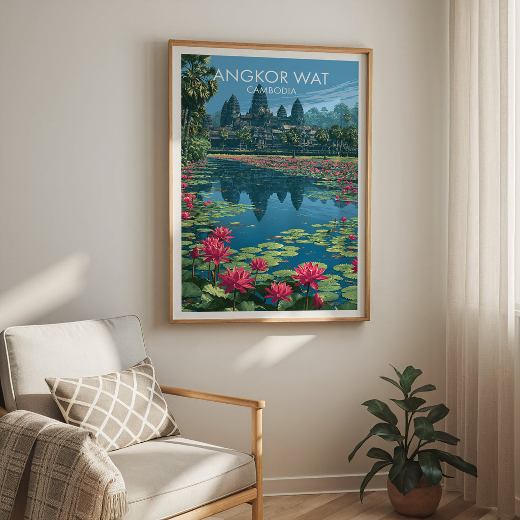 Angkor Wat Cambodia travel print in a light oak frame on a living room wall beside a linen armchair