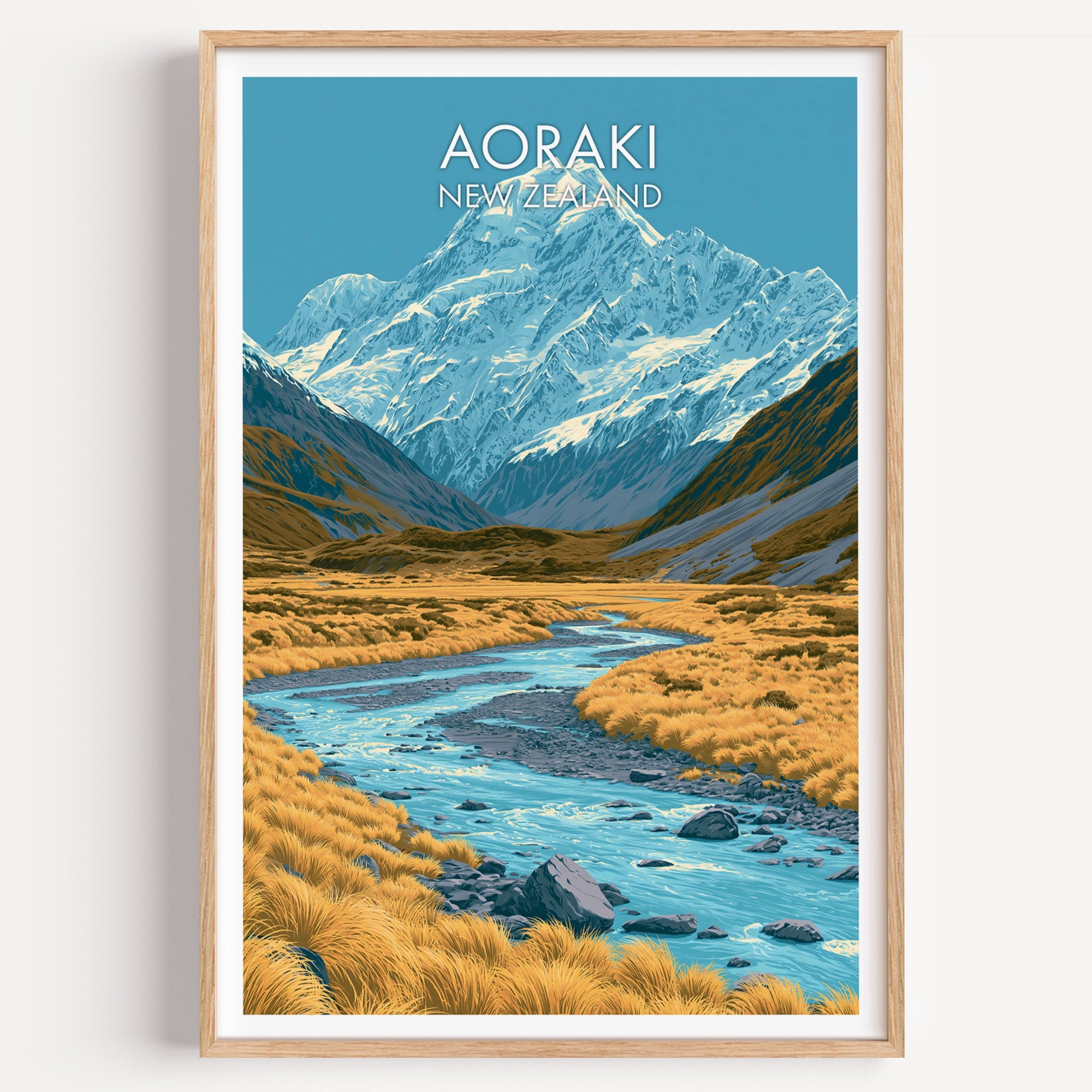 Aoraki Mount Cook travel print in a light oak frame on a plain white wall