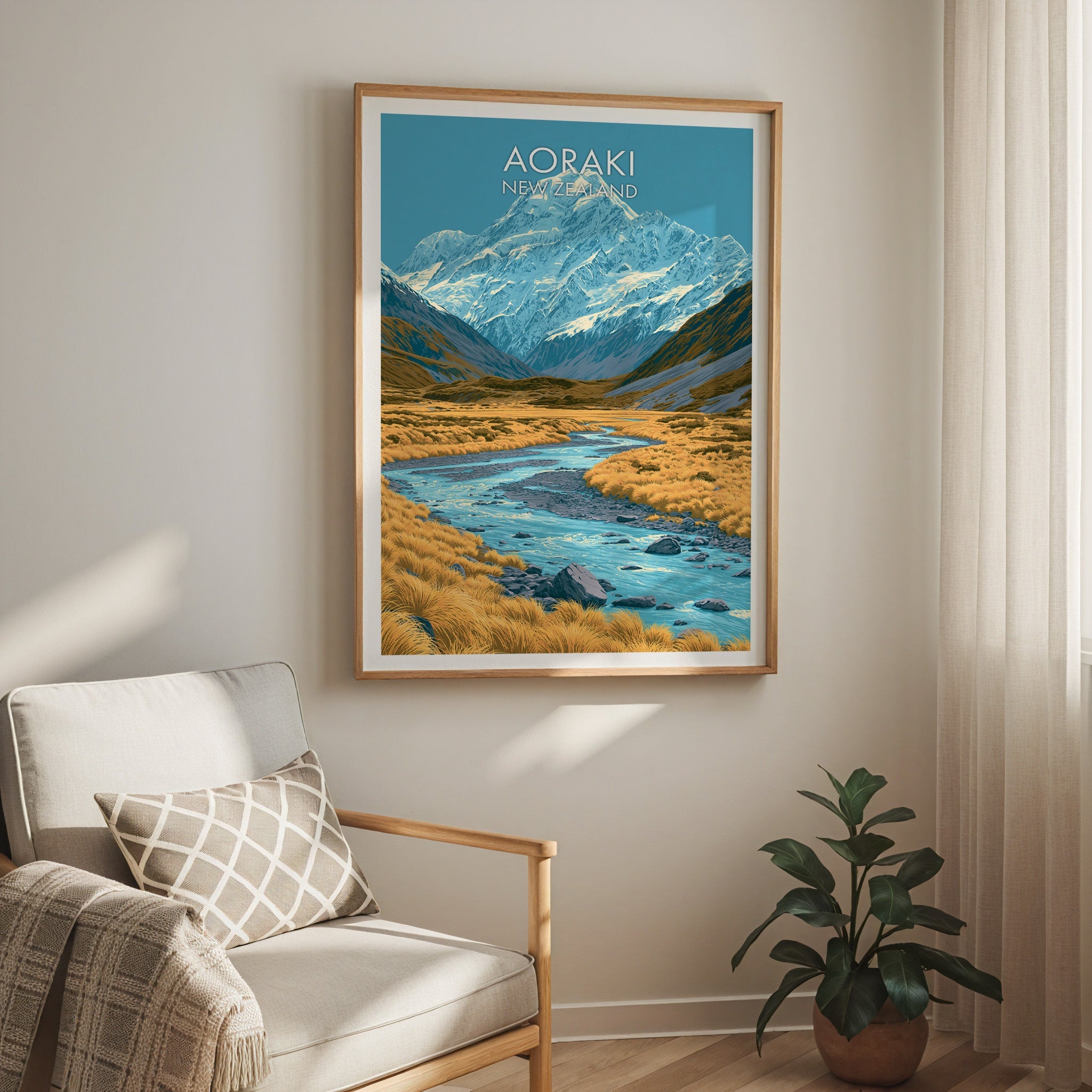 Glacier-blue mountain print in oak above a cream armchair, sheer curtain and potted rubber plant