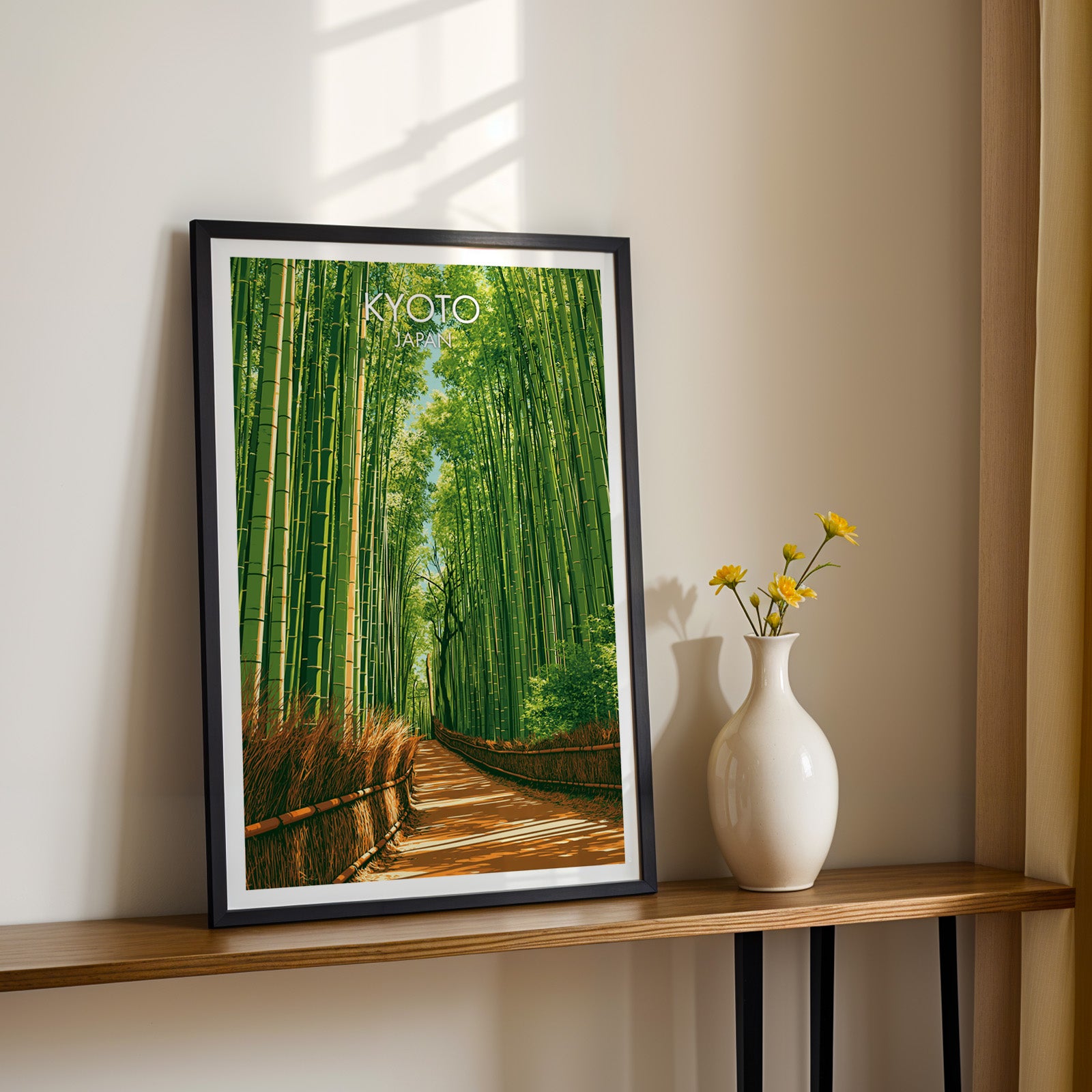 Black framed Arashiyama Bamboo Forest Kyoto print on a narrow hallway console in sunlight, styled with yellow flowers