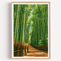 Arashiyama Bamboo Forest Kyoto travel poster in a natural wood frame, shown against a clean white wall