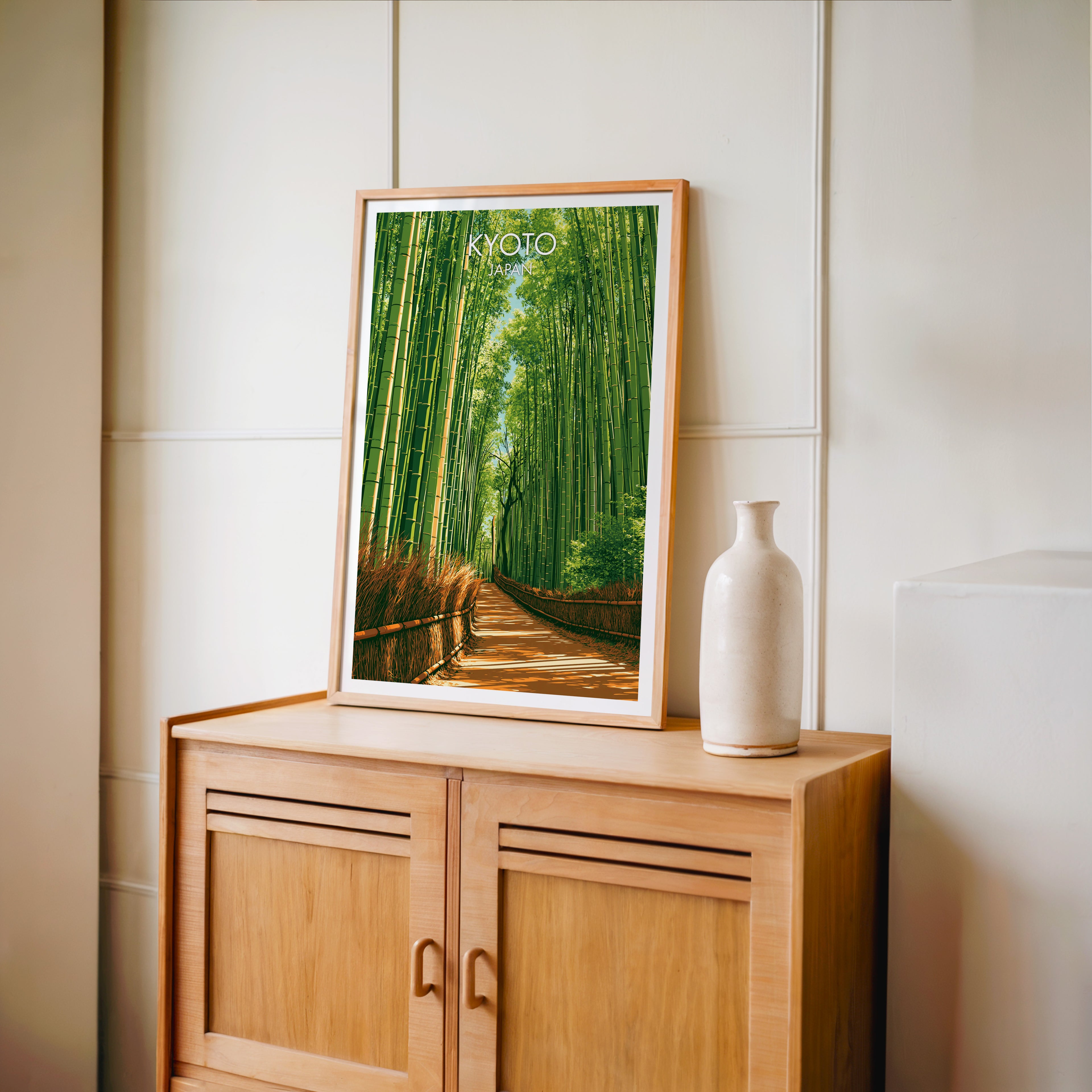 Small Arashiyama Bamboo Forest Kyoto travel poster in an oak frame on a mid-century sideboard with a ceramic vase