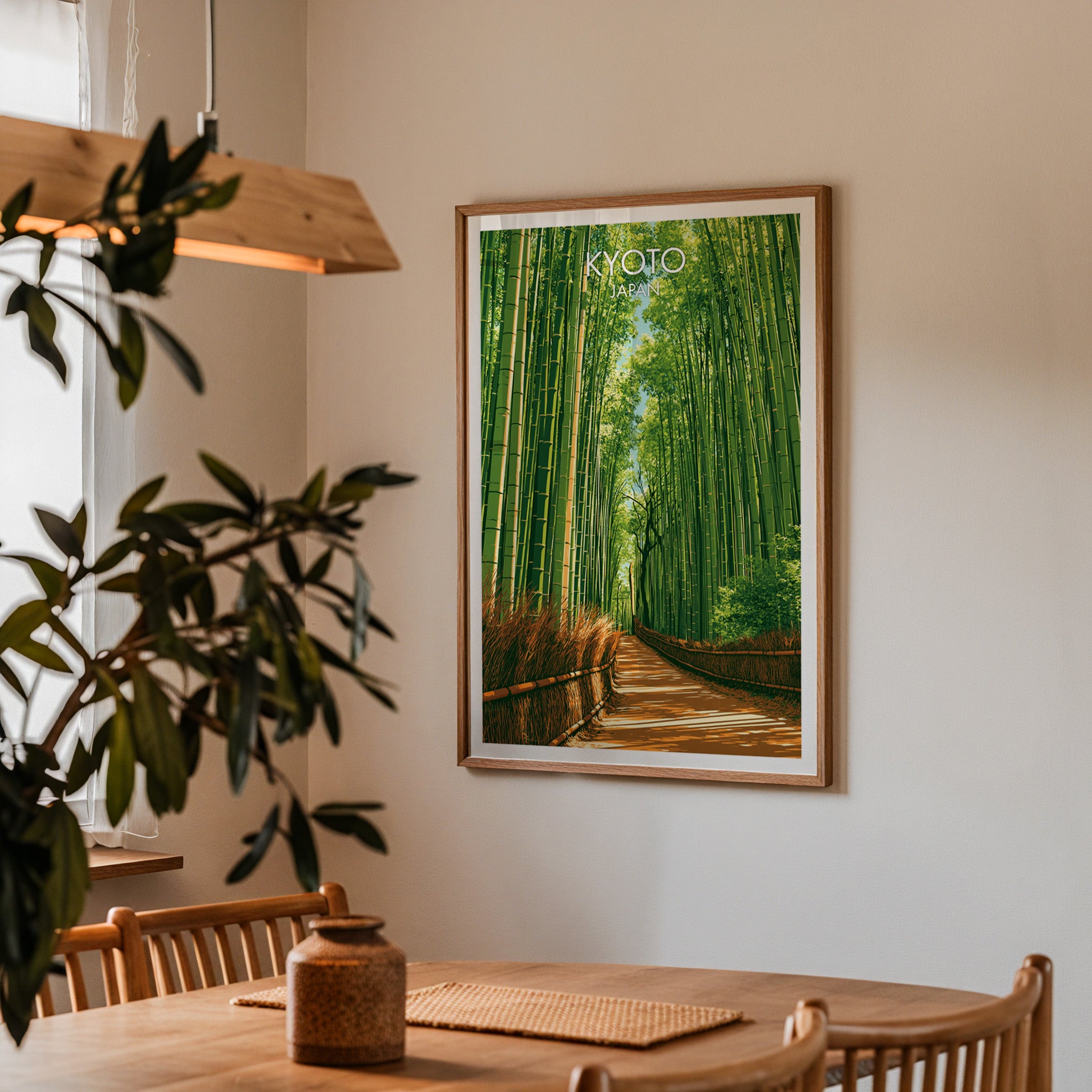 Framed Arashiyama Bamboo Forest Kyoto print on a dining room wall above an oak table in warm afternoon light