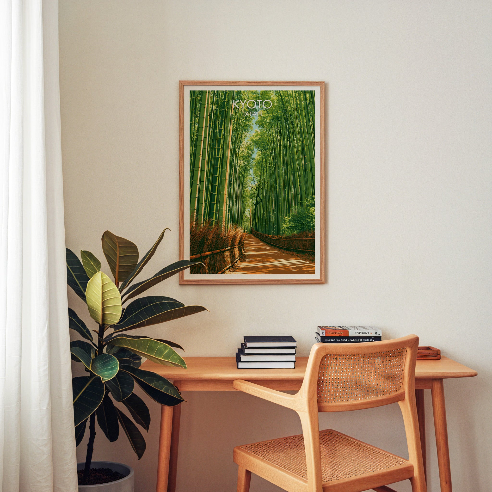 Arashiyama Bamboo Forest Kyoto wall art above a wooden home office desk with a rattan chair and books