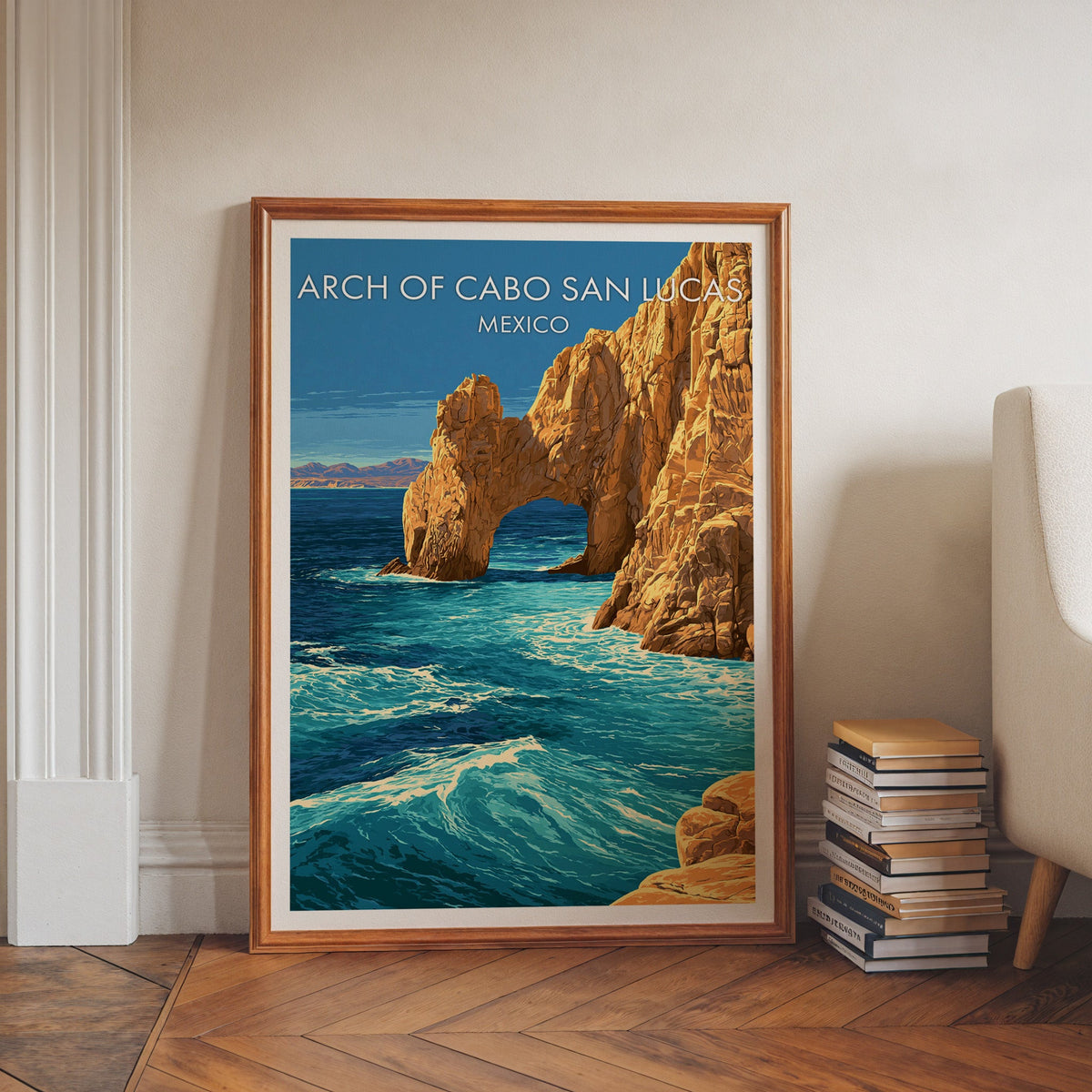 Cabo rock arch in a walnut frame on a herringbone floor with stacked books and a pale armchair