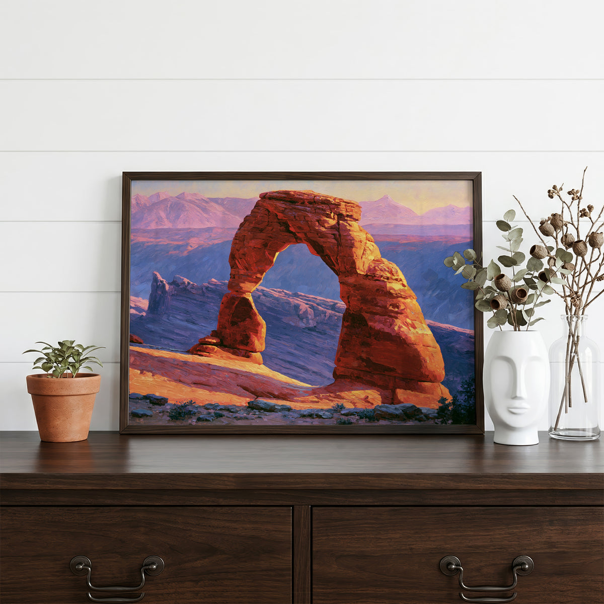 Arches classical oil painting in a walnut frame resting on a dark wood dresser