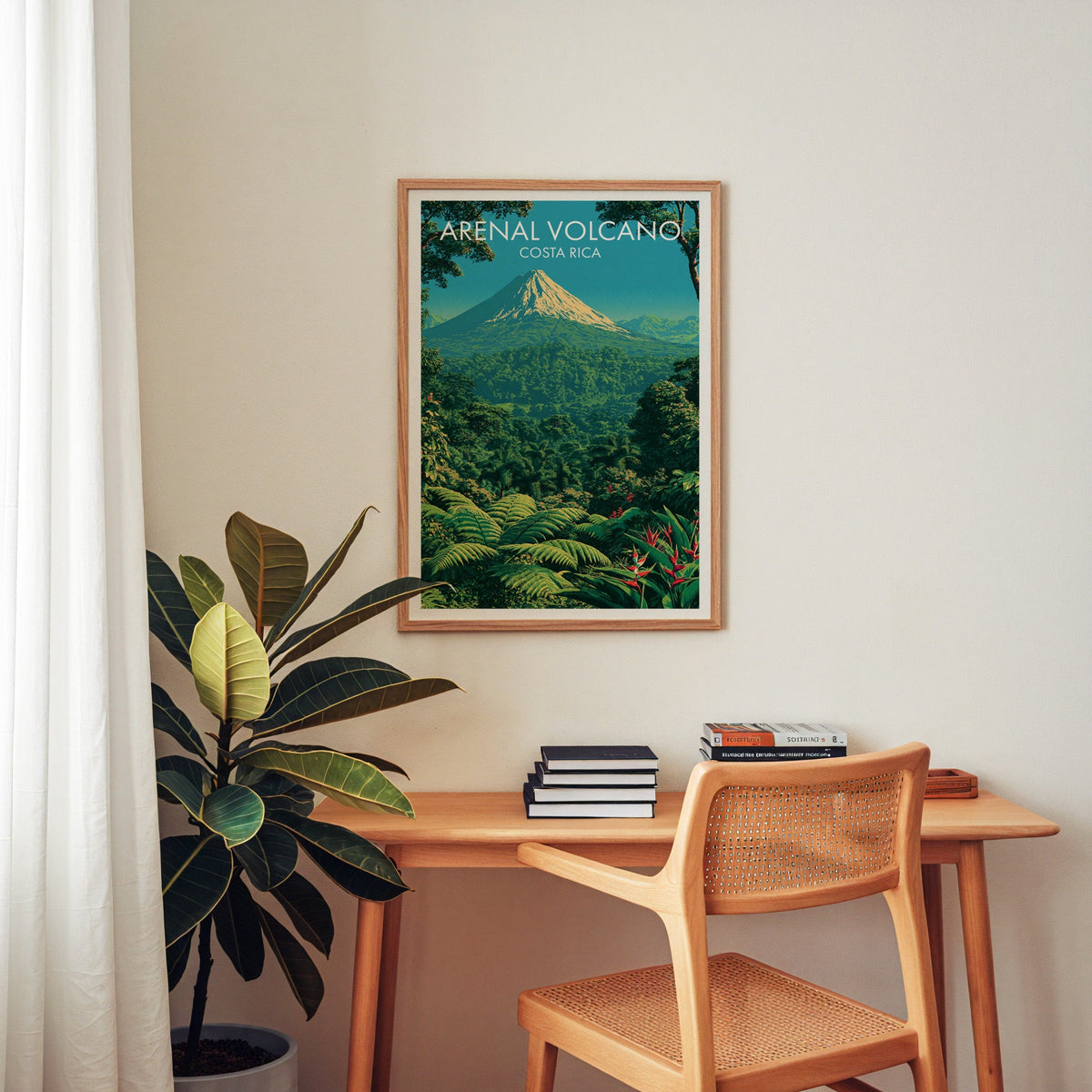 Central America travel print in an oak frame above a home-office desk with a cane chair and rubber plant