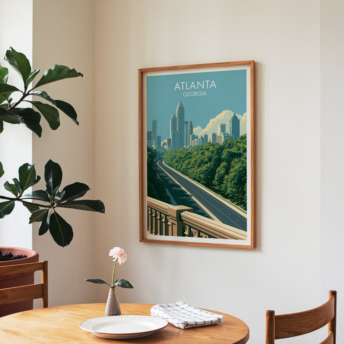 Atlanta poster in a walnut frame in a dining corner with a round table, checked runner and roses