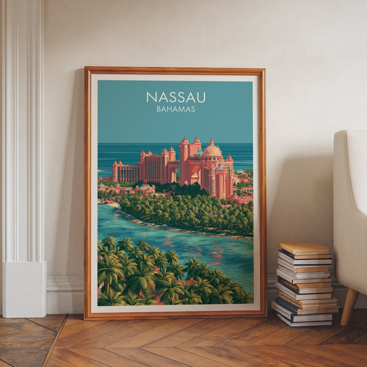 Tropical blue and pink print in a walnut frame leaning on herringbone floor beside stacked books