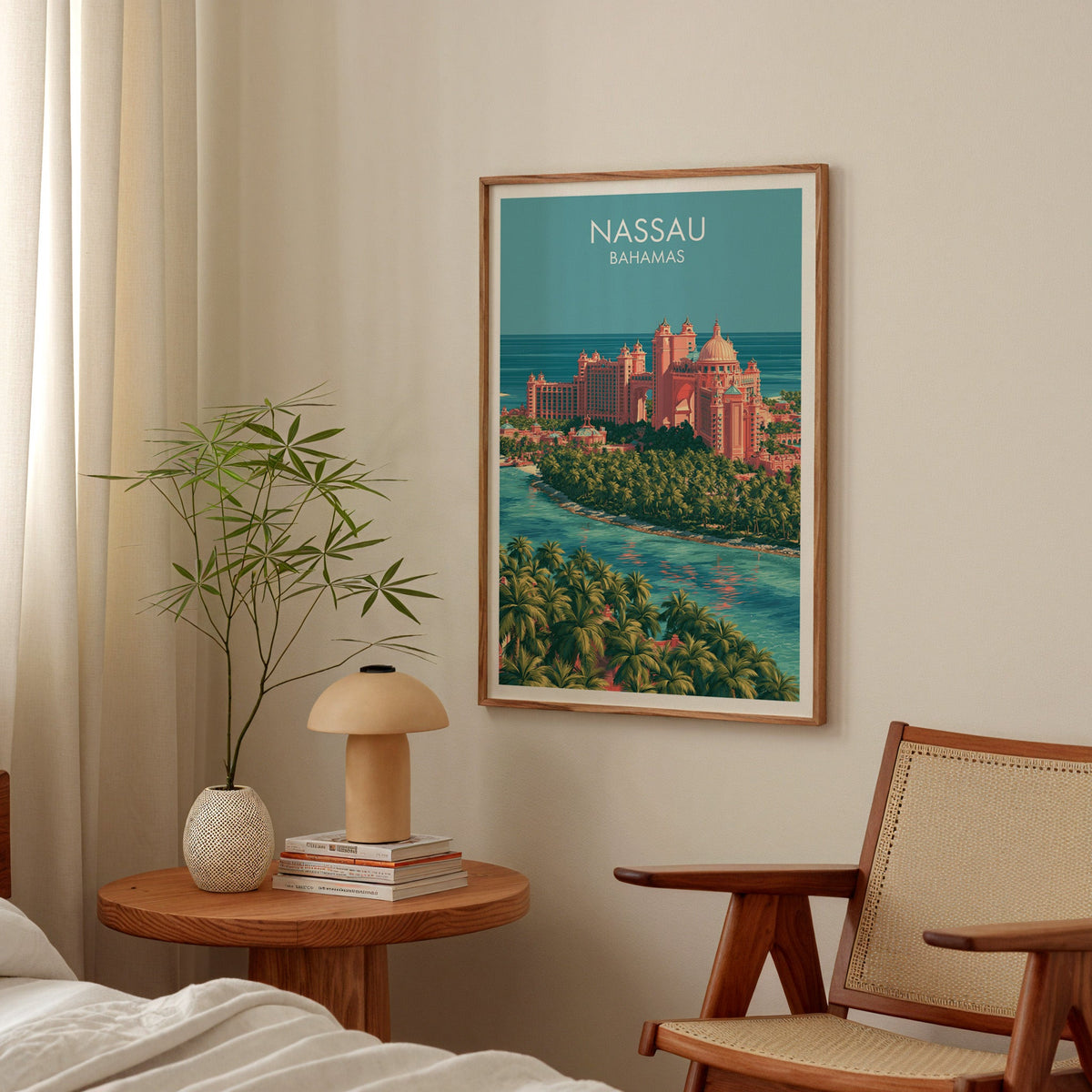 Paradise Island travel art in an oak frame above a bedside table with a mushroom lamp and bamboo stems