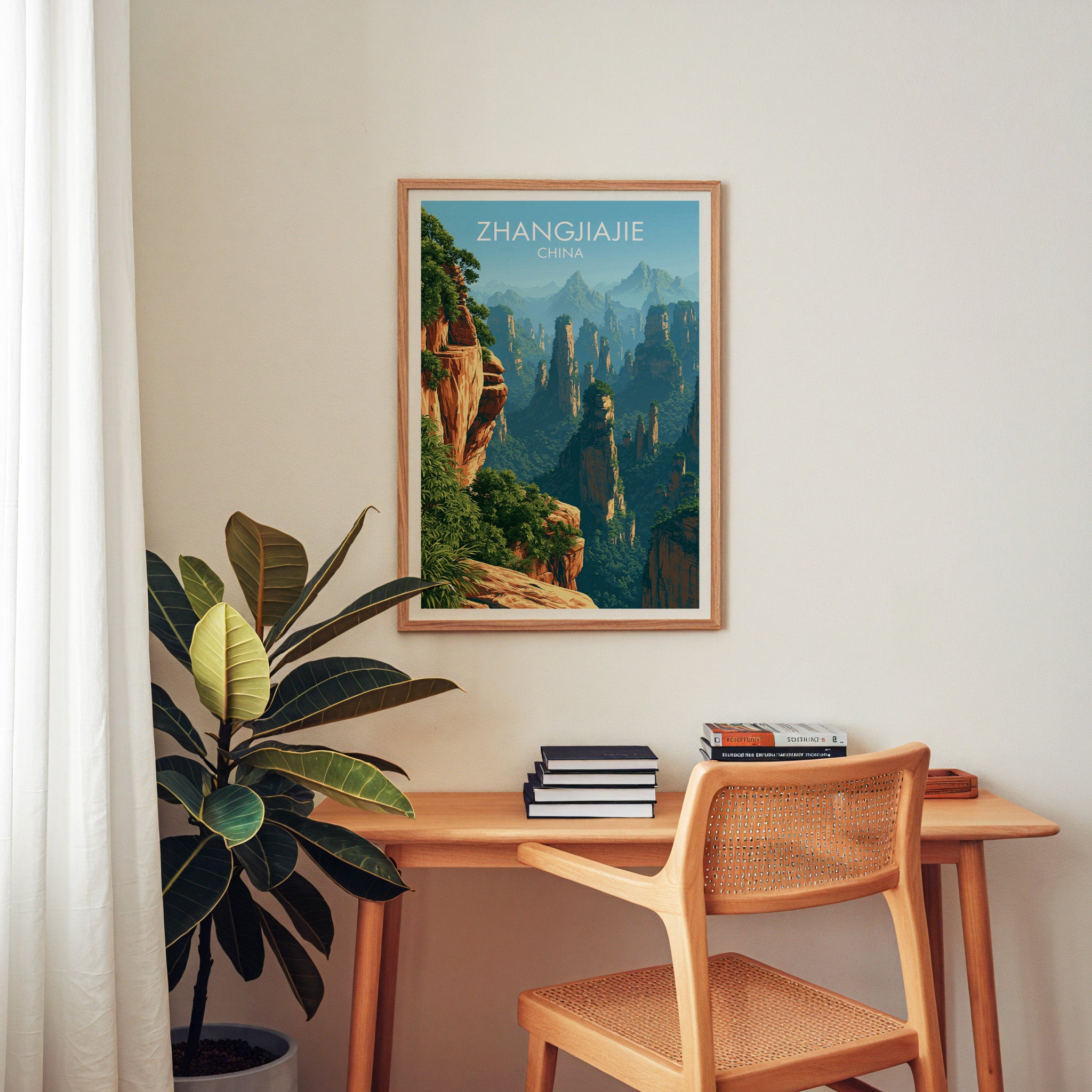 Zhangjiajie China wall art above a wooden home office desk with a rattan chair and books