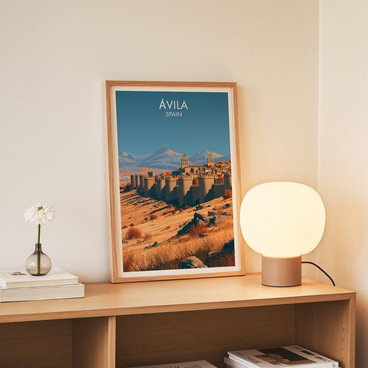 Avila Spain wall art, slim oak frame standing on an oak console beside a daisy in a glass bottle