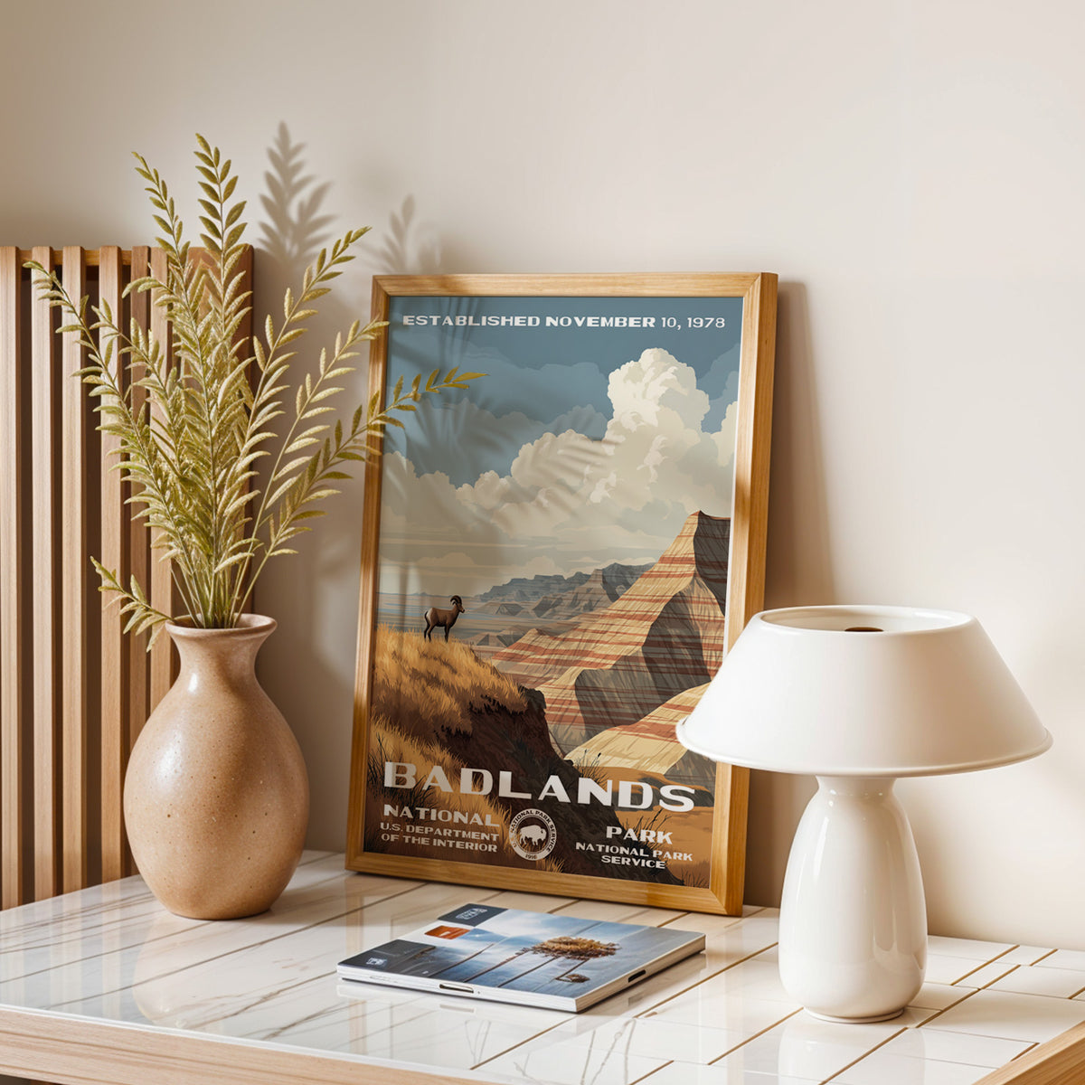 Badlands National Park vintage print leaning on a table with a ceramic lamp and dried grasses