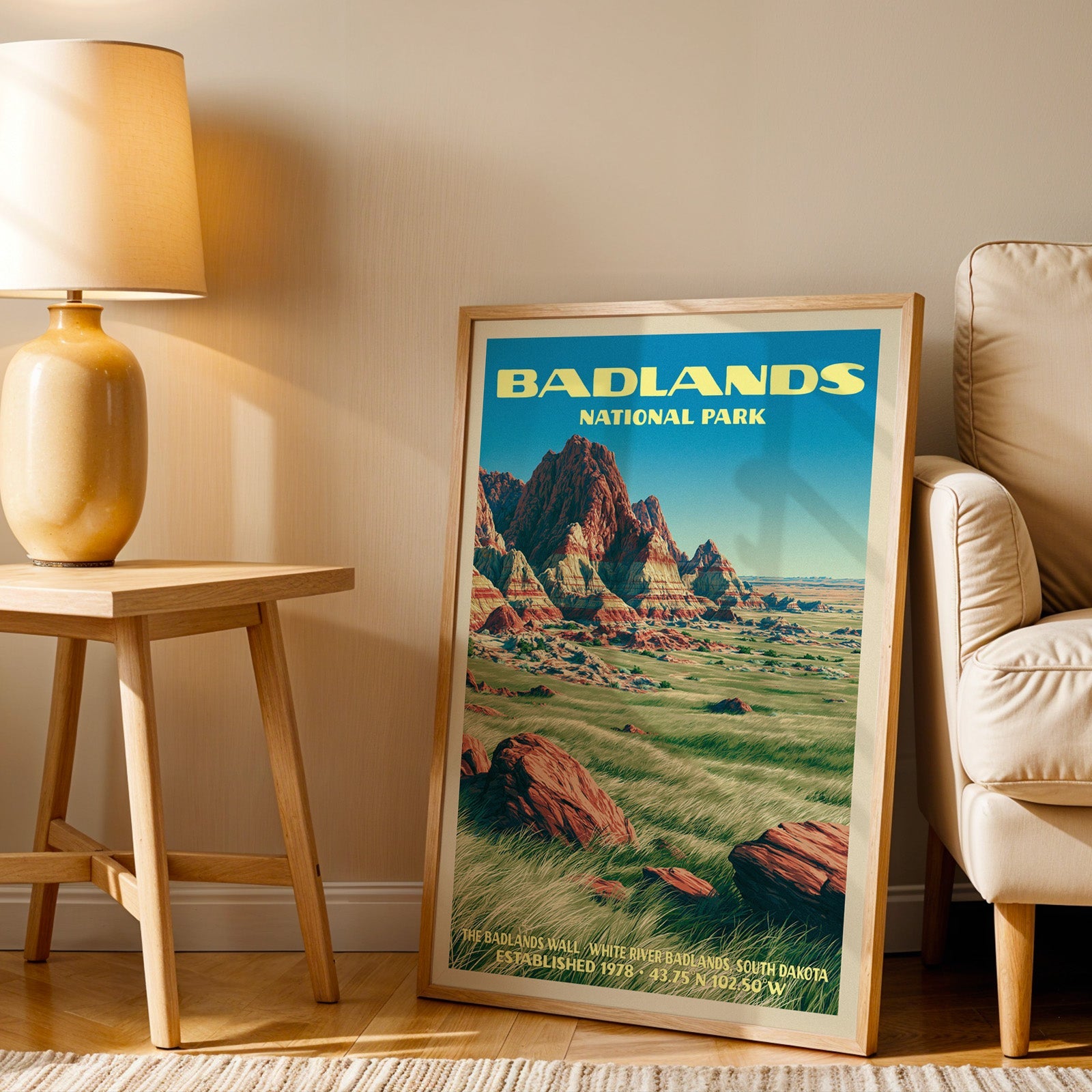 Badlands Wall art print in oak, leaning by an armchair and a side table with an ochre lamp