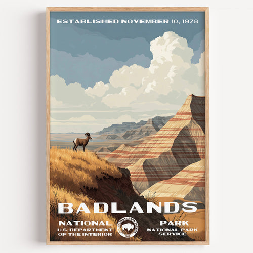 Badlands National Park vintage travel poster in a wood frame, a bighorn sheep on a golden ridge above striped badland walls