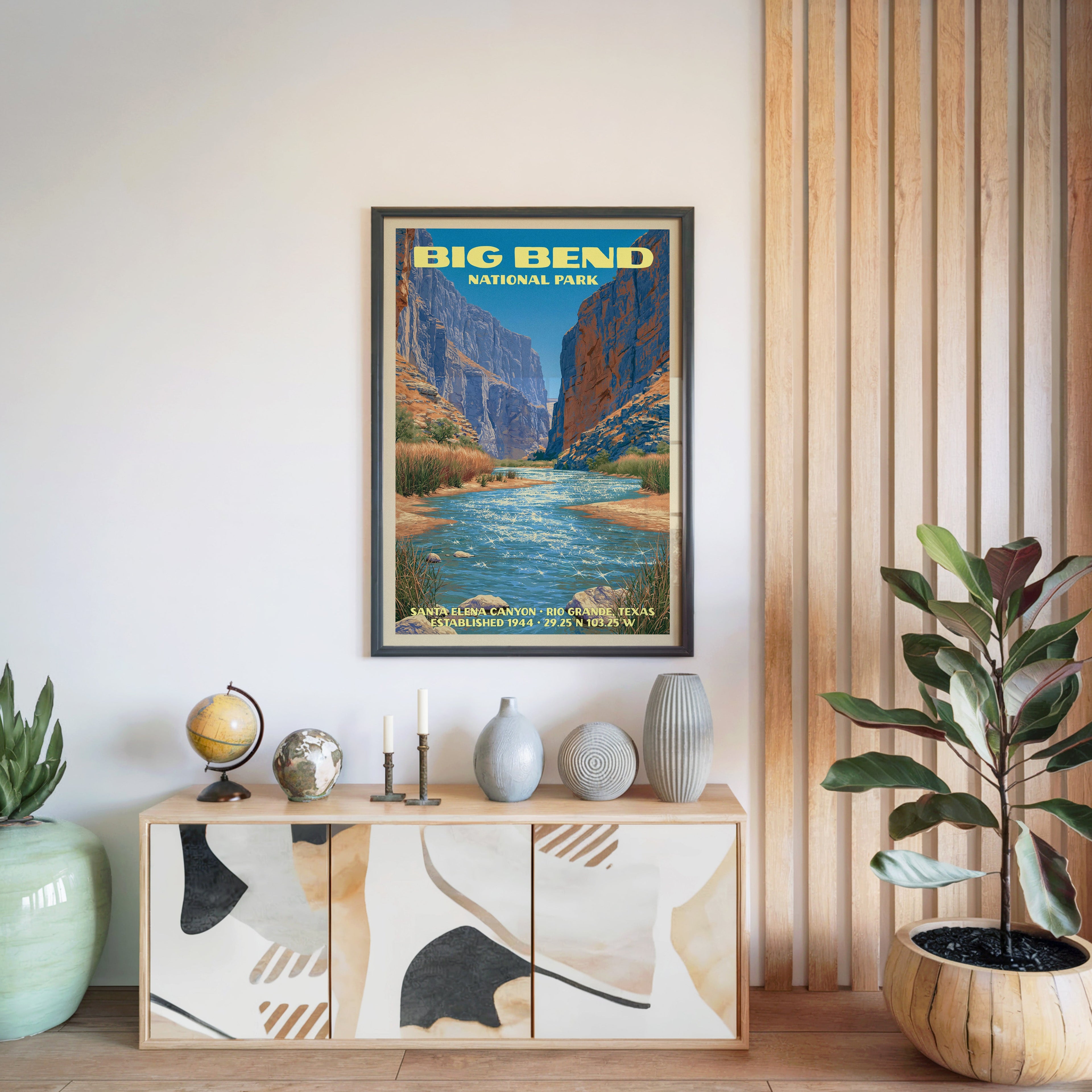 Big Bend National Park poster in a black frame above a light wood sideboard by a slatted wall panel