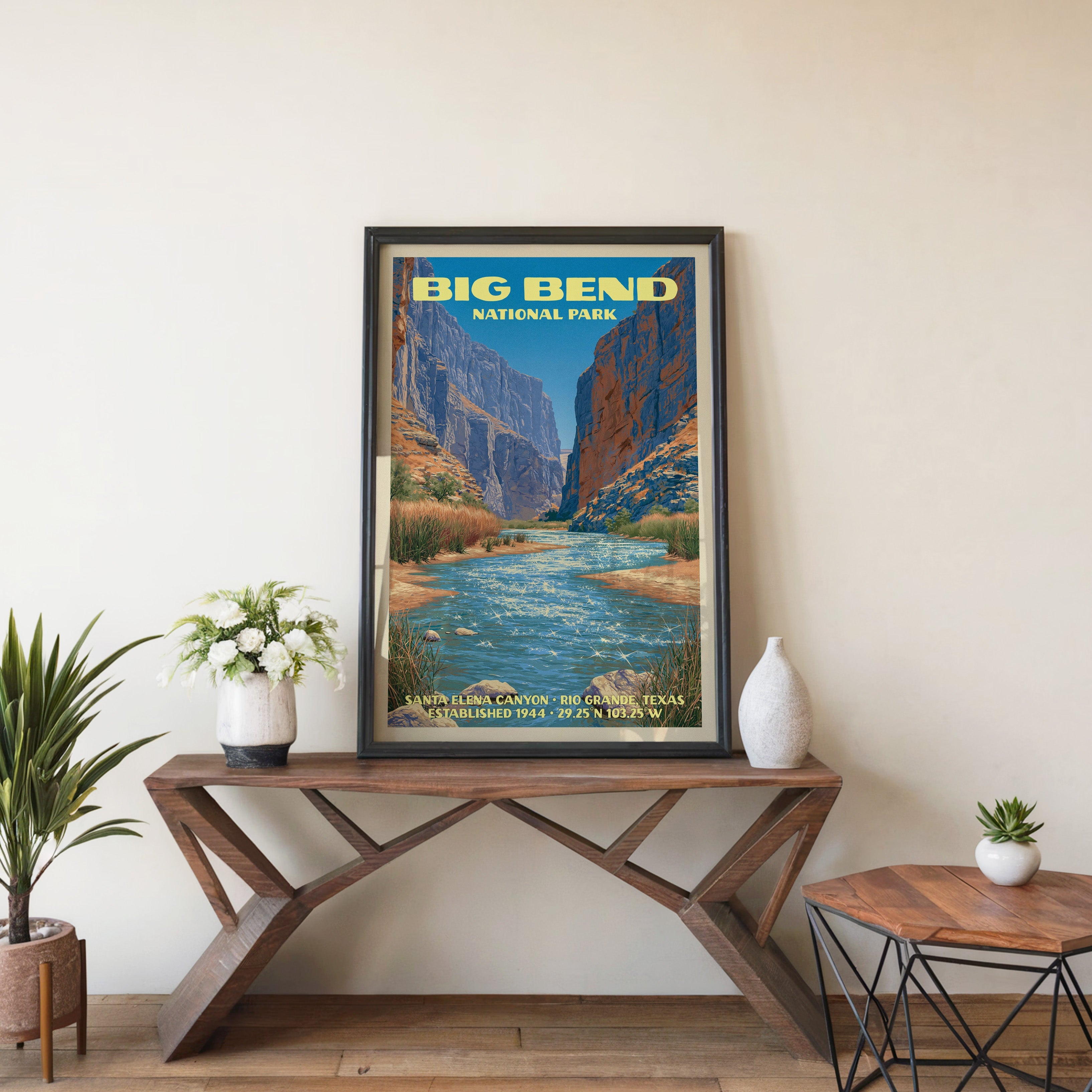 Big Bend Santa Elena Canyon wall art in black, leaning on a walnut console with white anemones and a vase