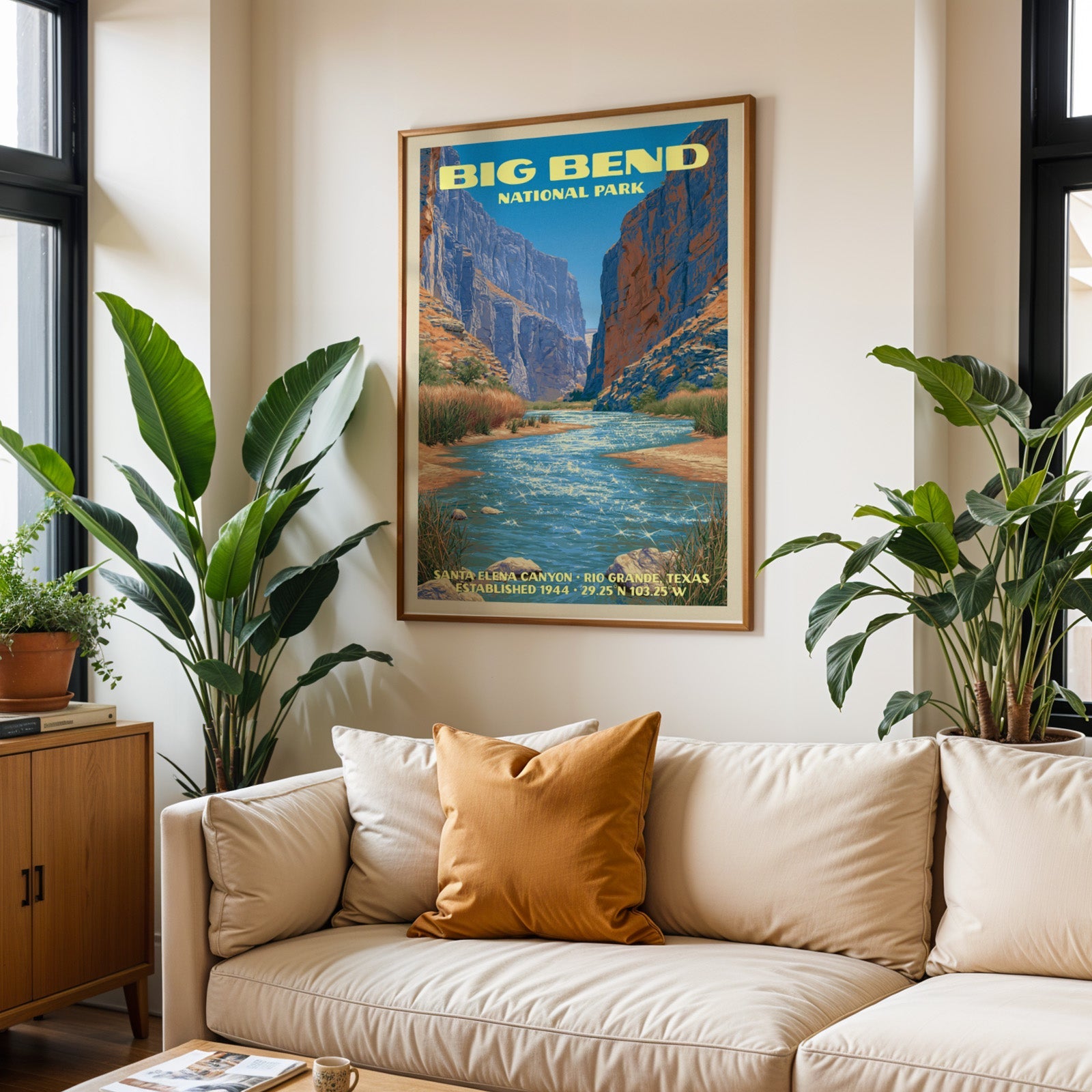 Big Bend vintage travel print in oak above a cream sofa with a rust cushion and tall houseplants