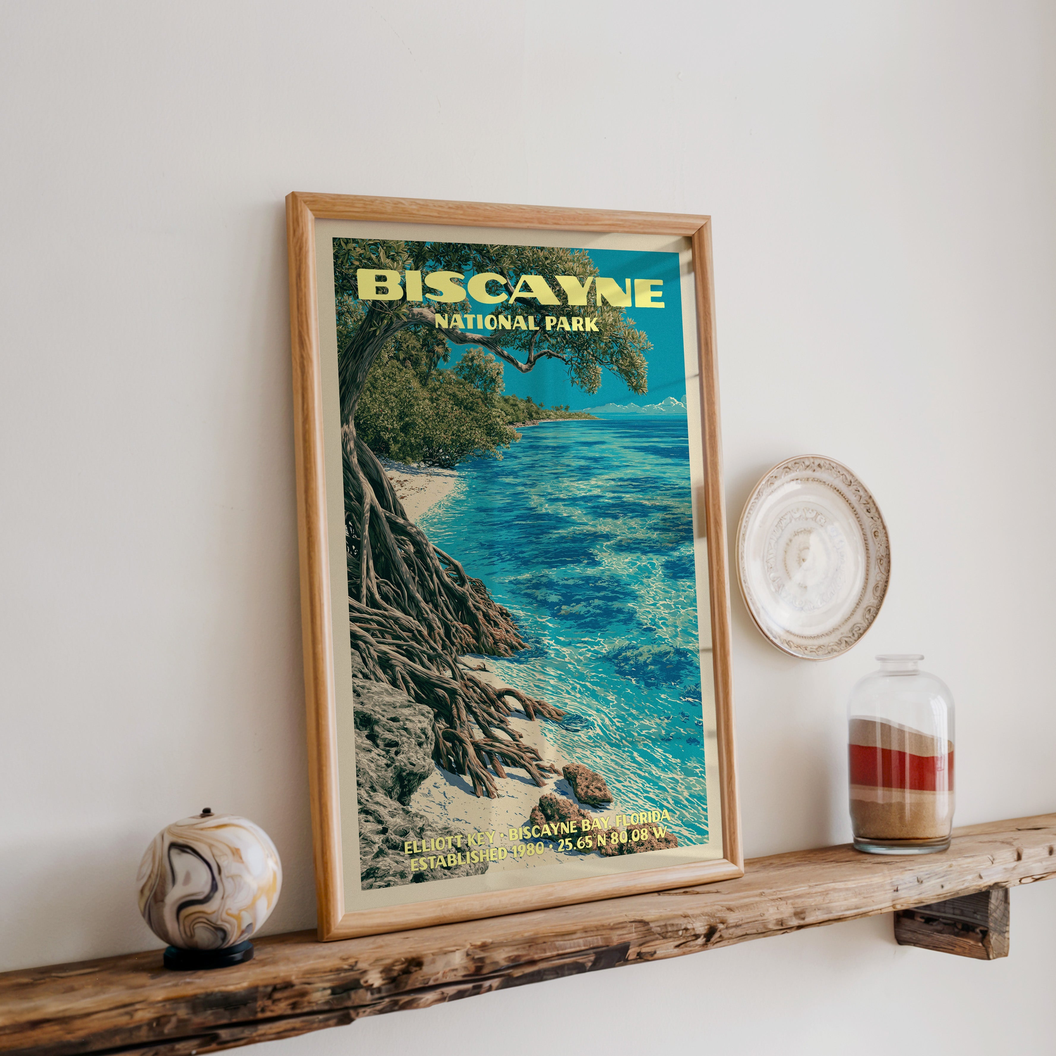 Biscayne Elliott Key print in oak, leaning on a reclaimed wood ledge with a stone sphere and a sand jar