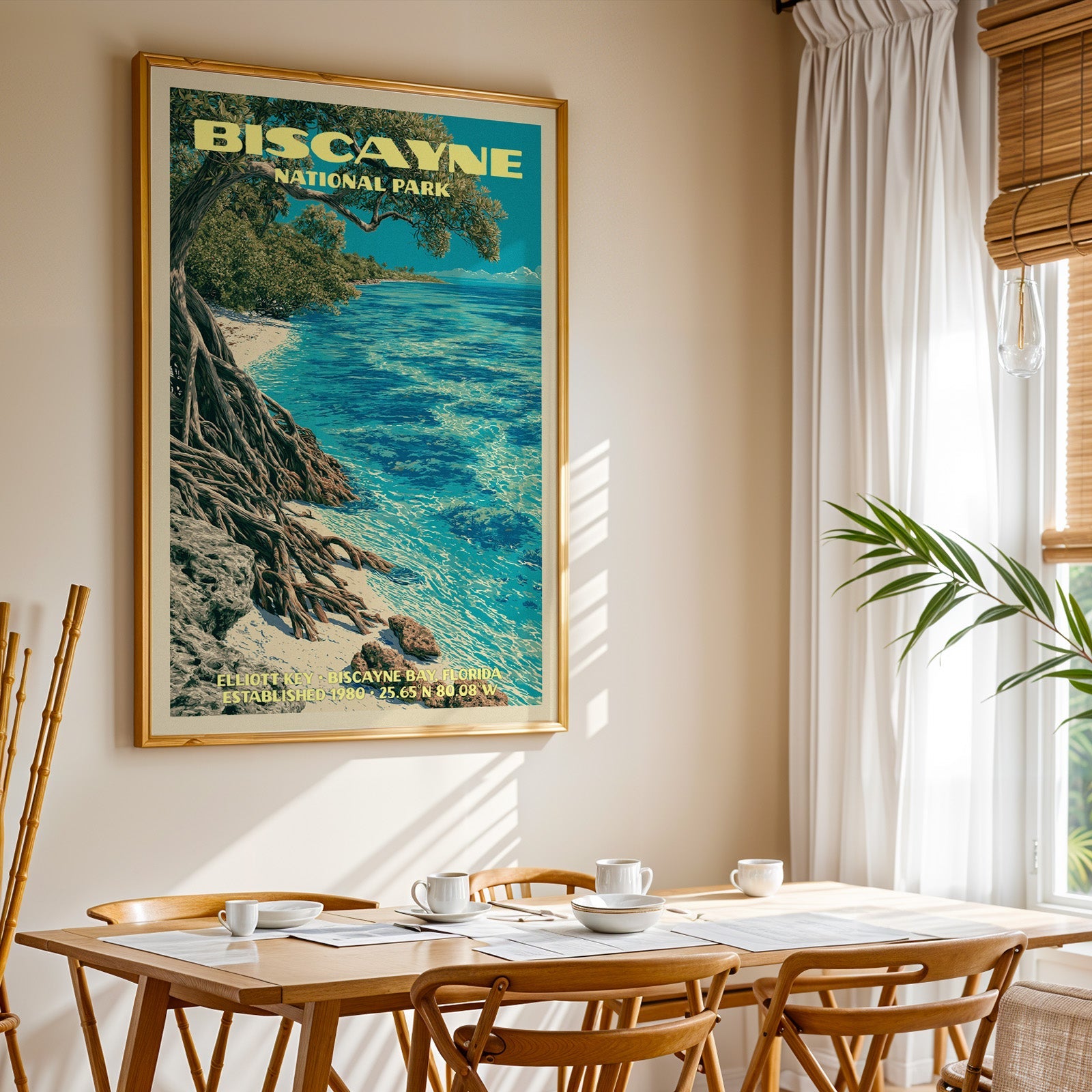 Biscayne National Park print in gold above a light oak dining table by a curtained window