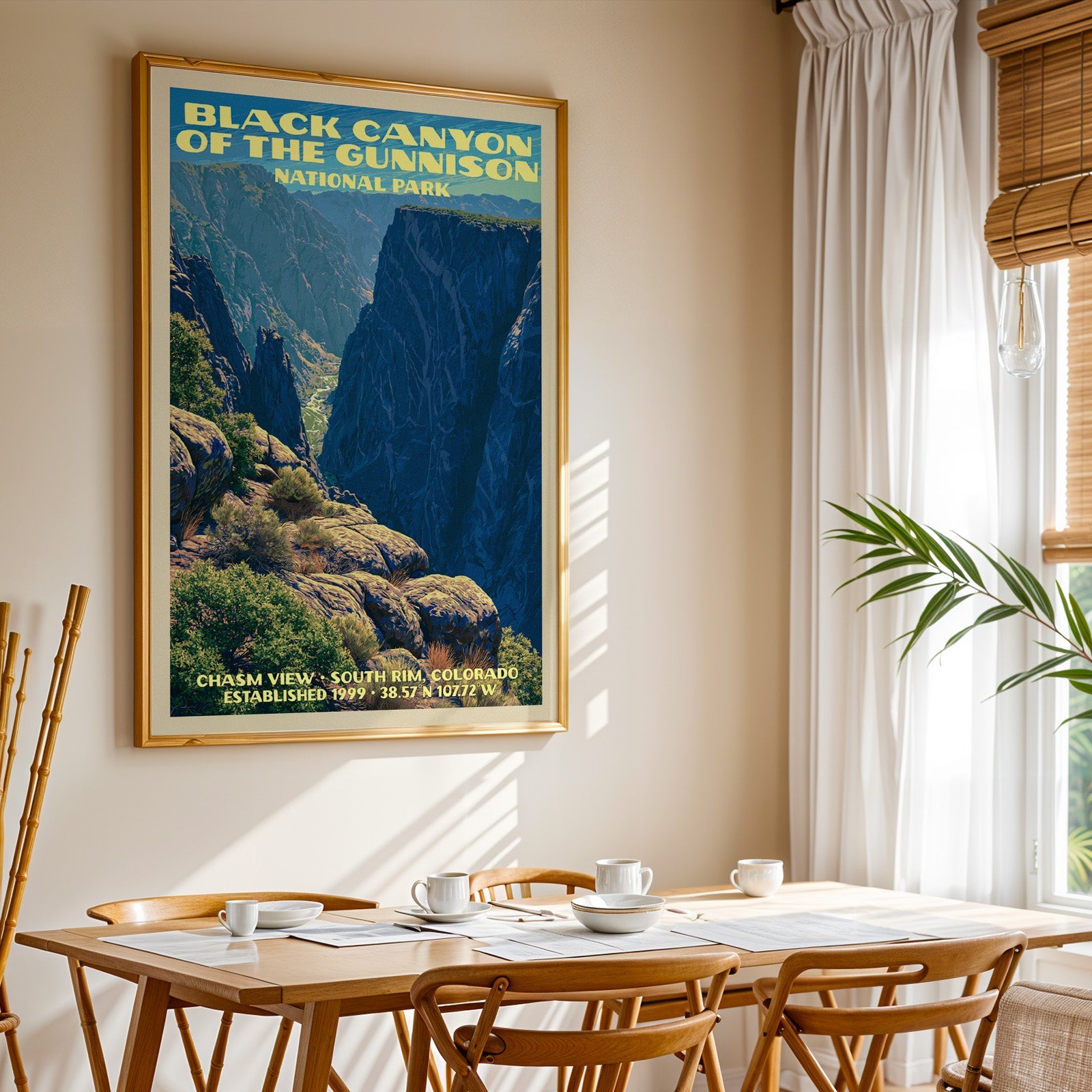 Black Canyon of the Gunnison print in gold above a light oak dining table by a curtained window