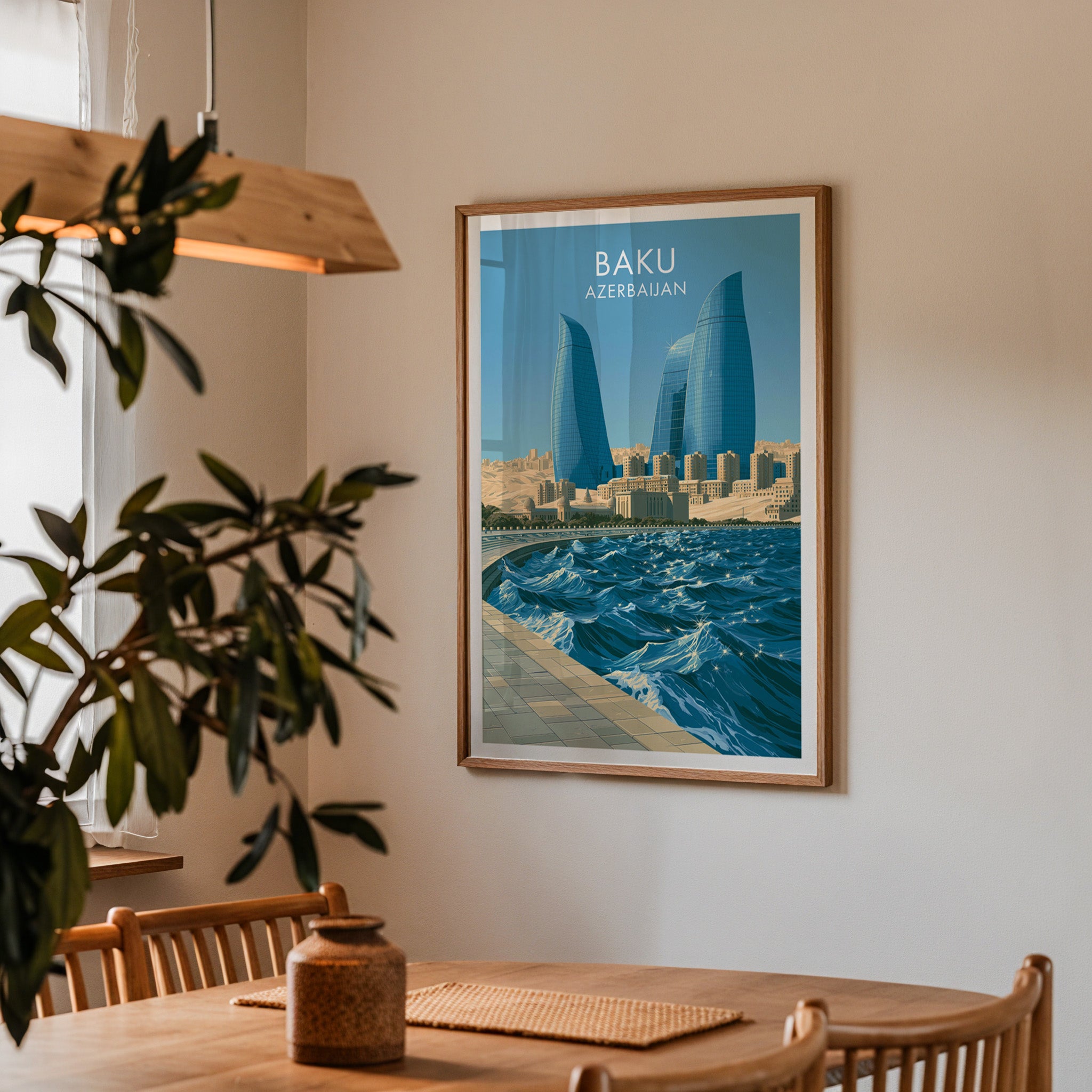 Framed Baku Azerbaijan print on a dining room wall above an oak table in warm afternoon light