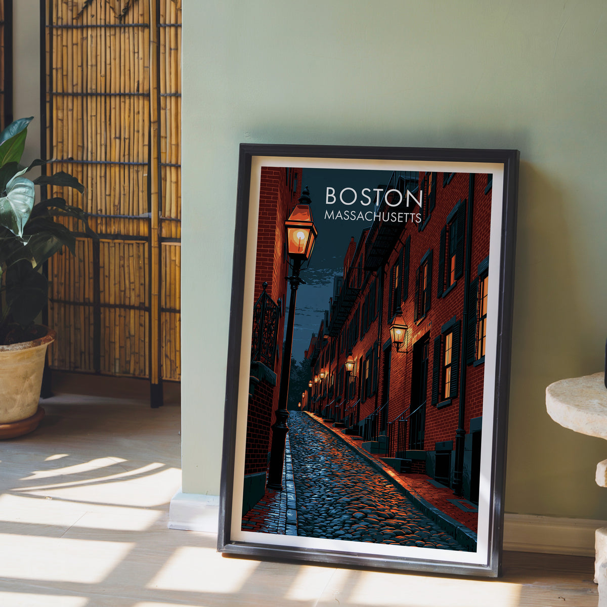 Beacon Hill print in a black frame on a sage green wall with a bamboo screen and an orchid in clay