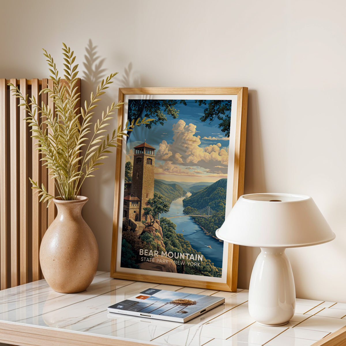 Oak-framed river gorge print on a stone table with dried leaves, a mushroom lamp and magazines